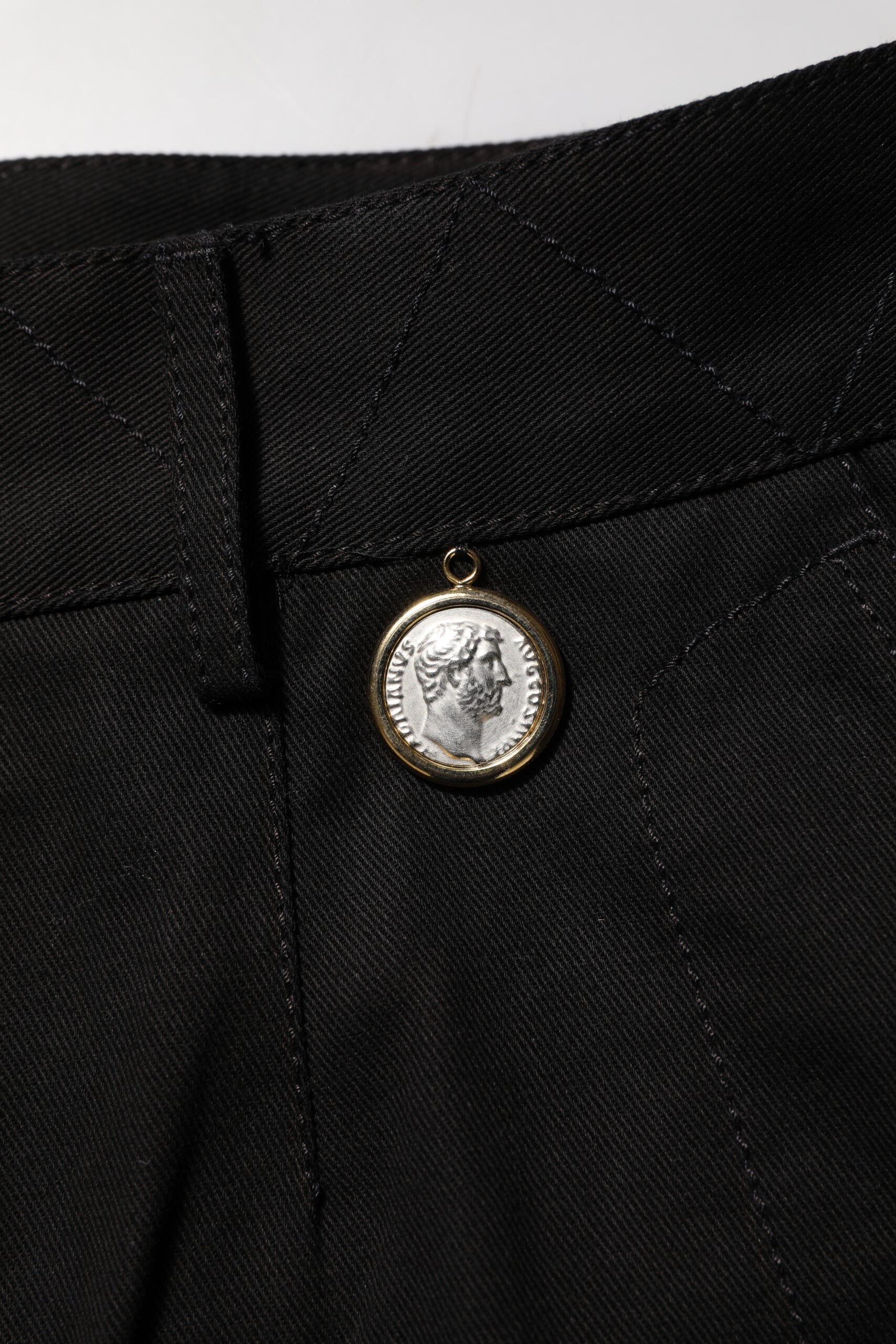 Gold coin on black fabric