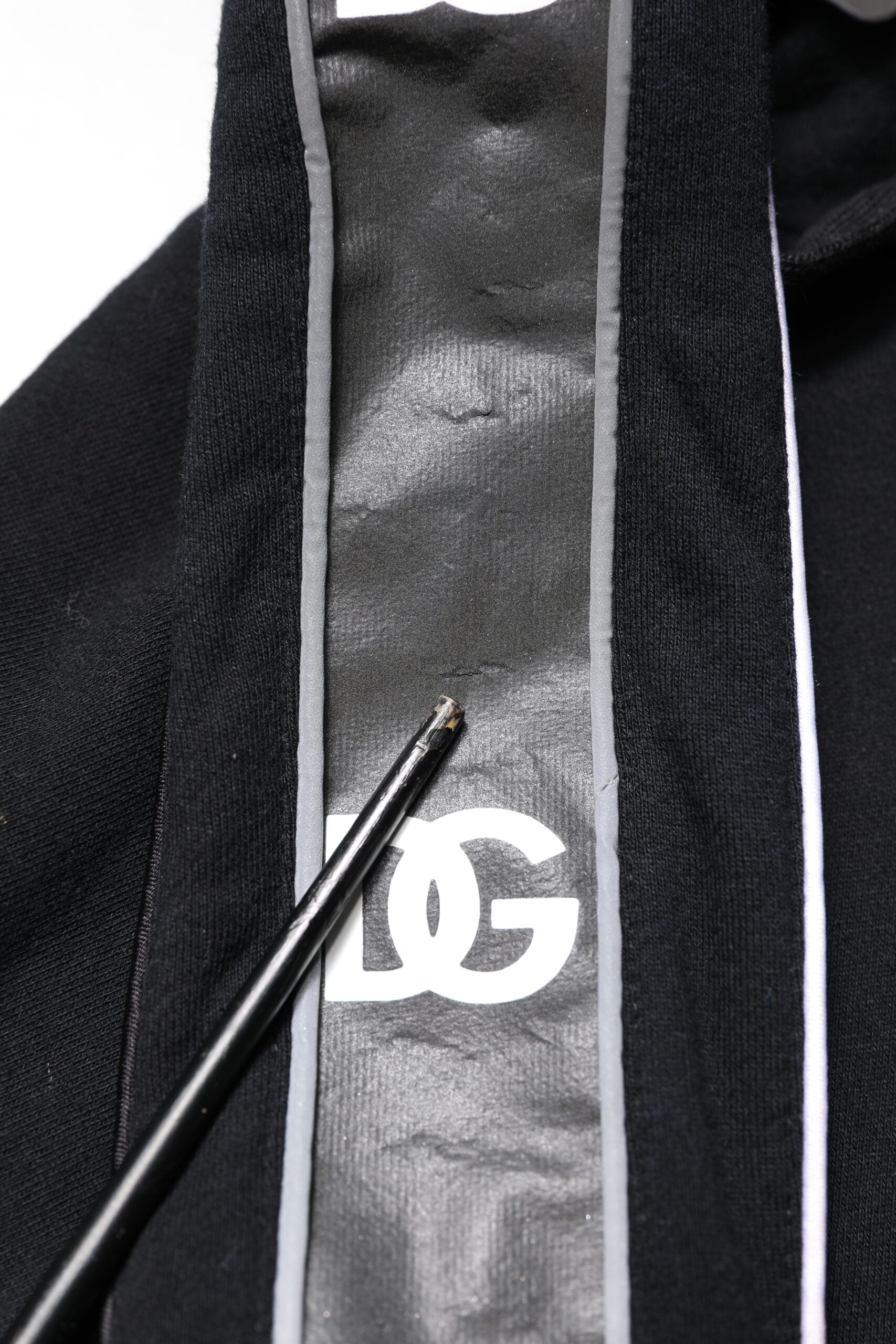 Black towel with white stripe and gold lettering