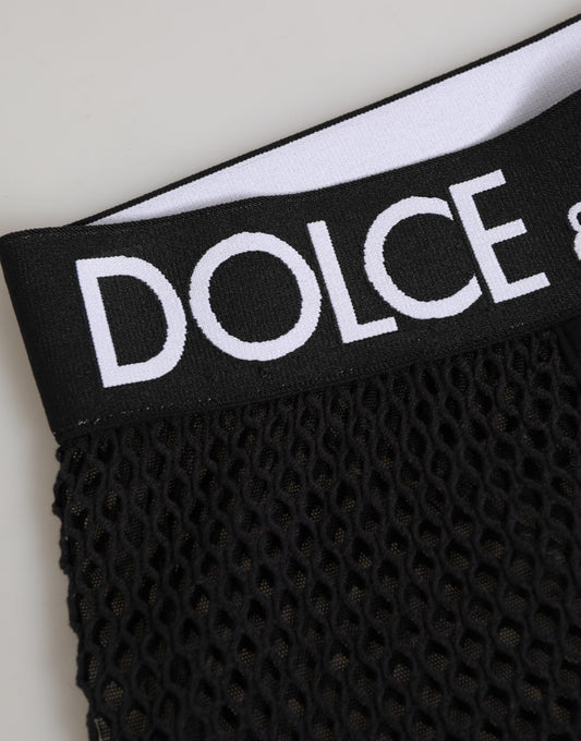 Black cotton logo shorts with midi trousers underneath