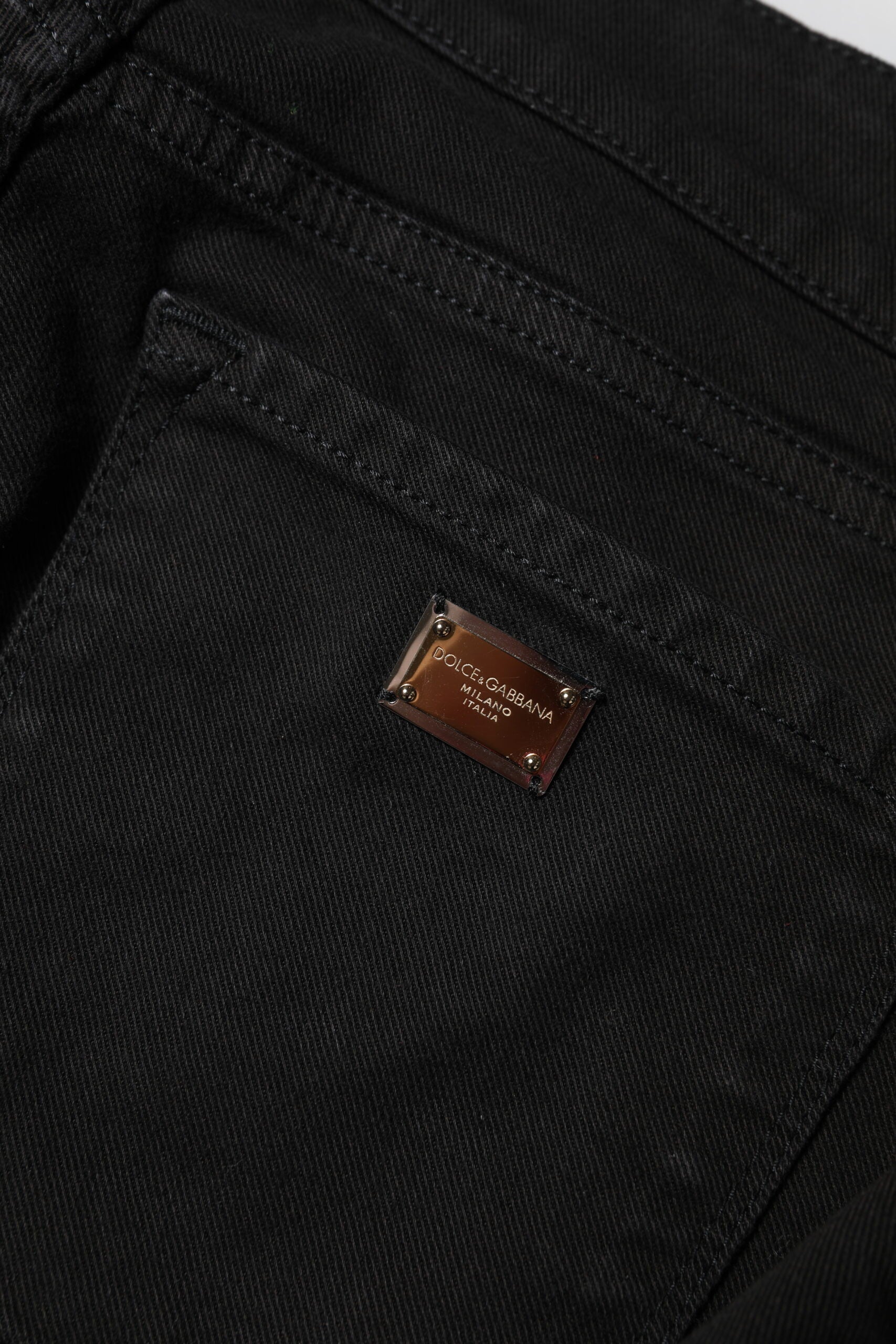 Black denim jeans with a brown label on the waistband