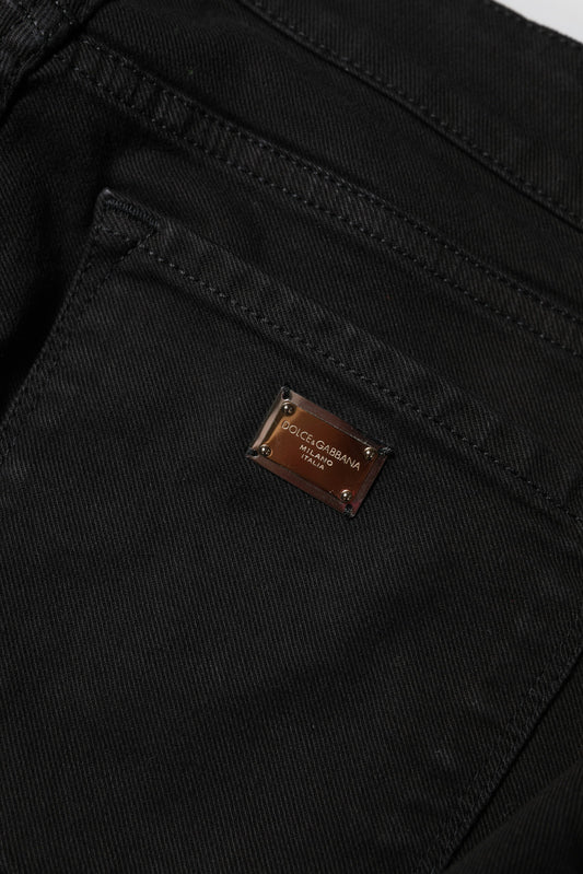 Black denim jeans with a brown label on the waistband