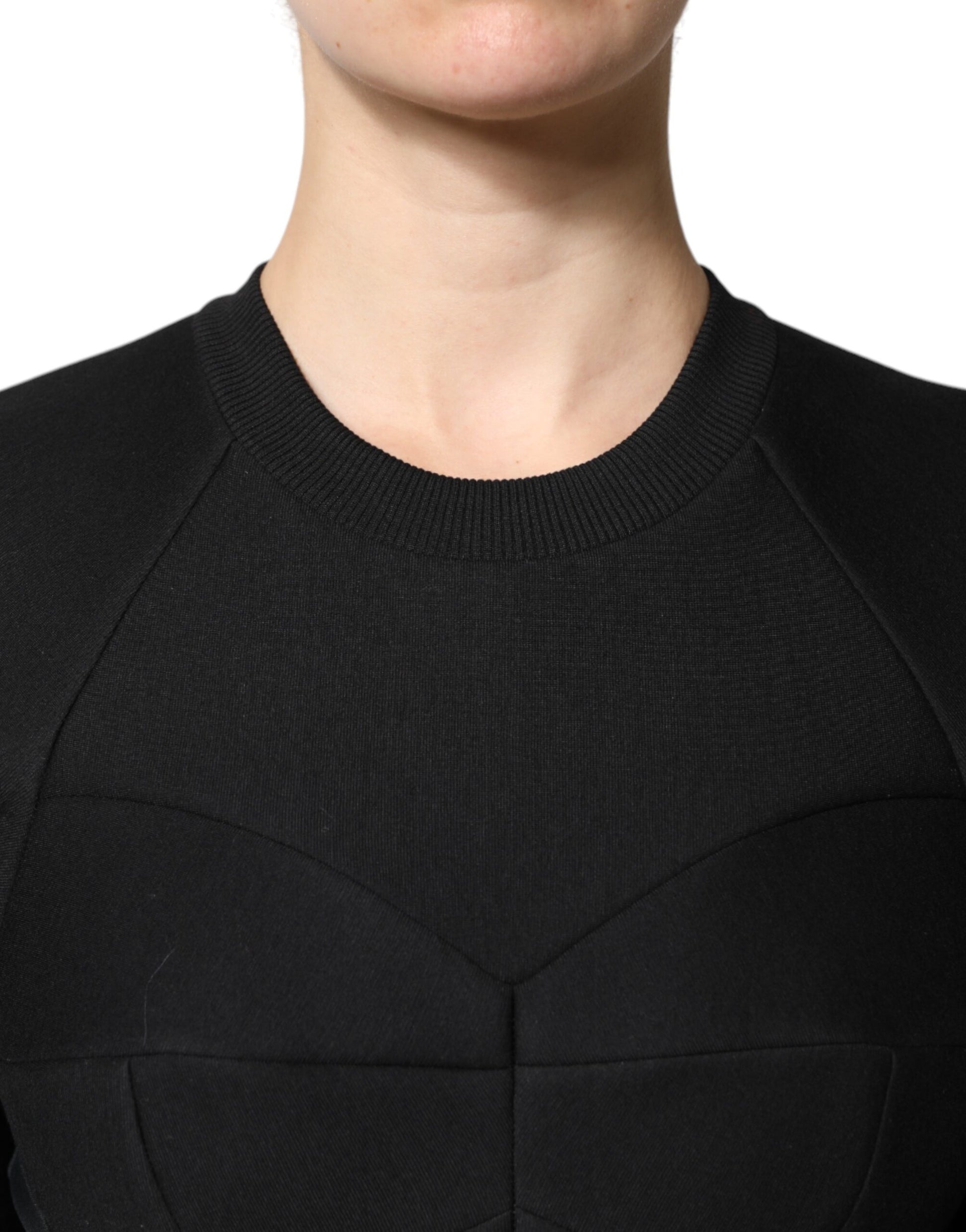 A black cotton long sleeve dress with an A-line silhouette