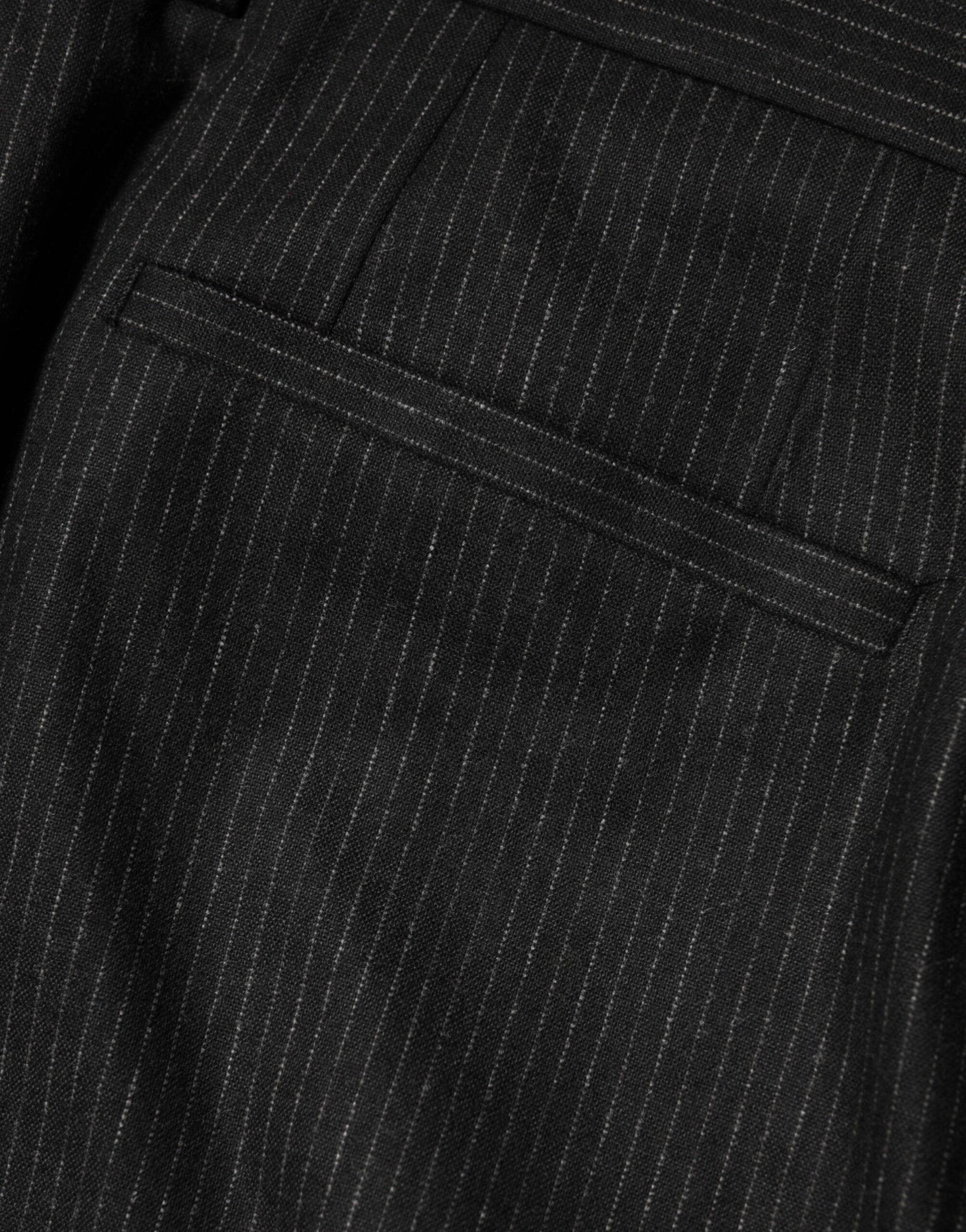 A pair of black mid-waist dress trousers with a textured fabric