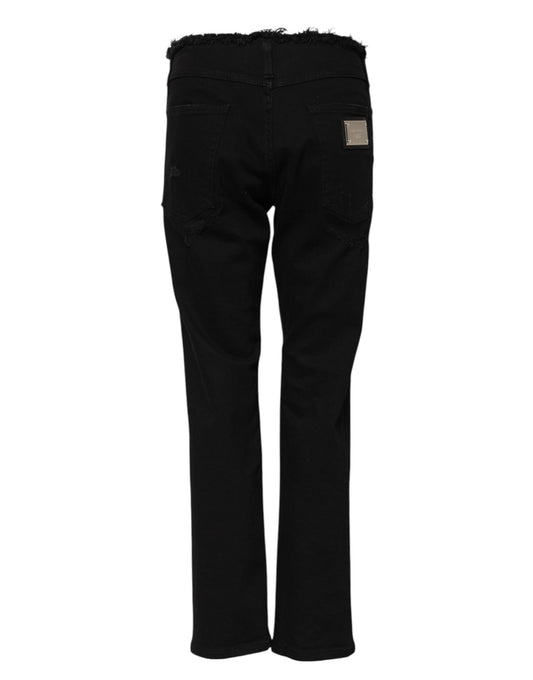 Pair of black jeans with faded areas and distressed details