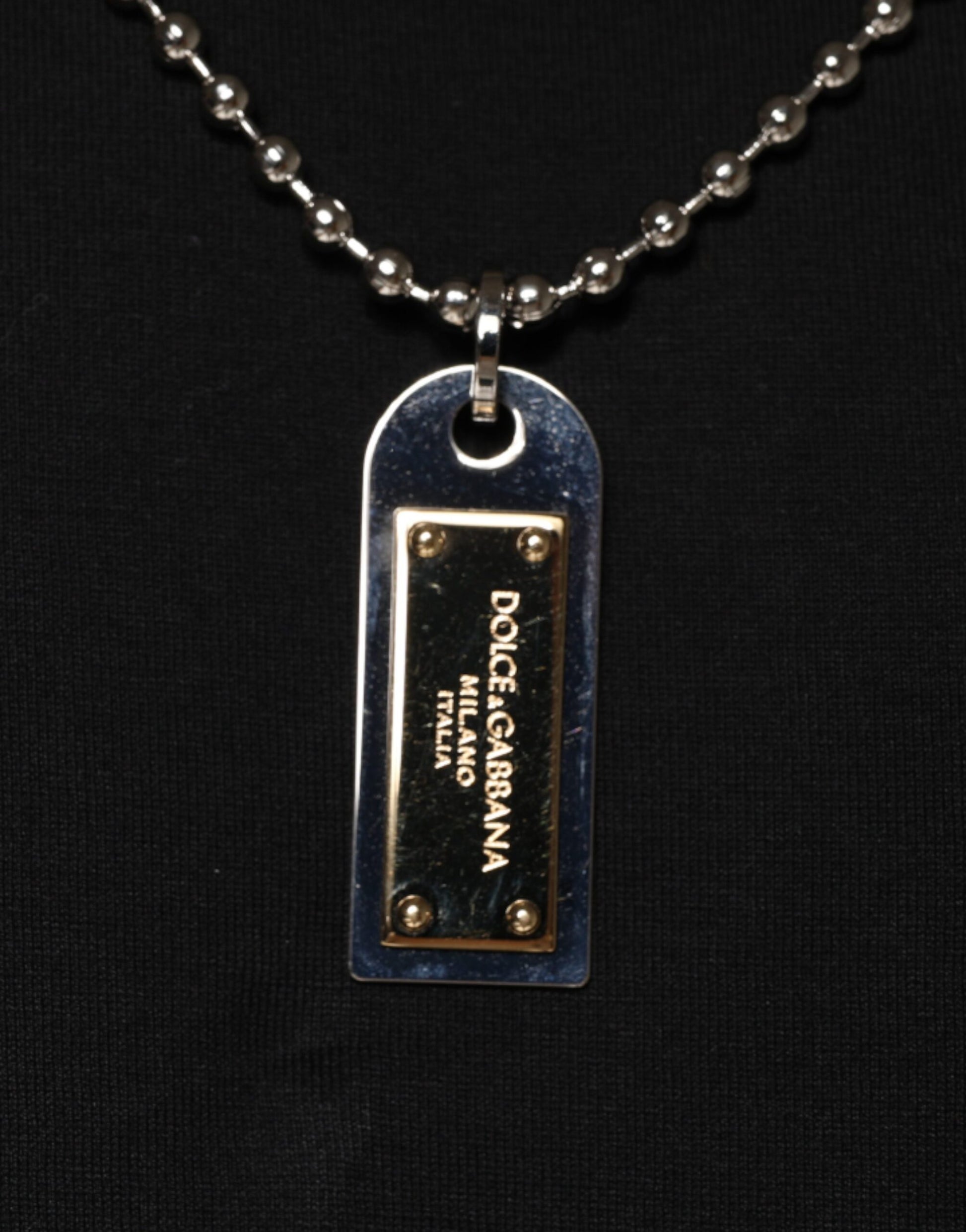 Silver necklace with a metal tag pendant