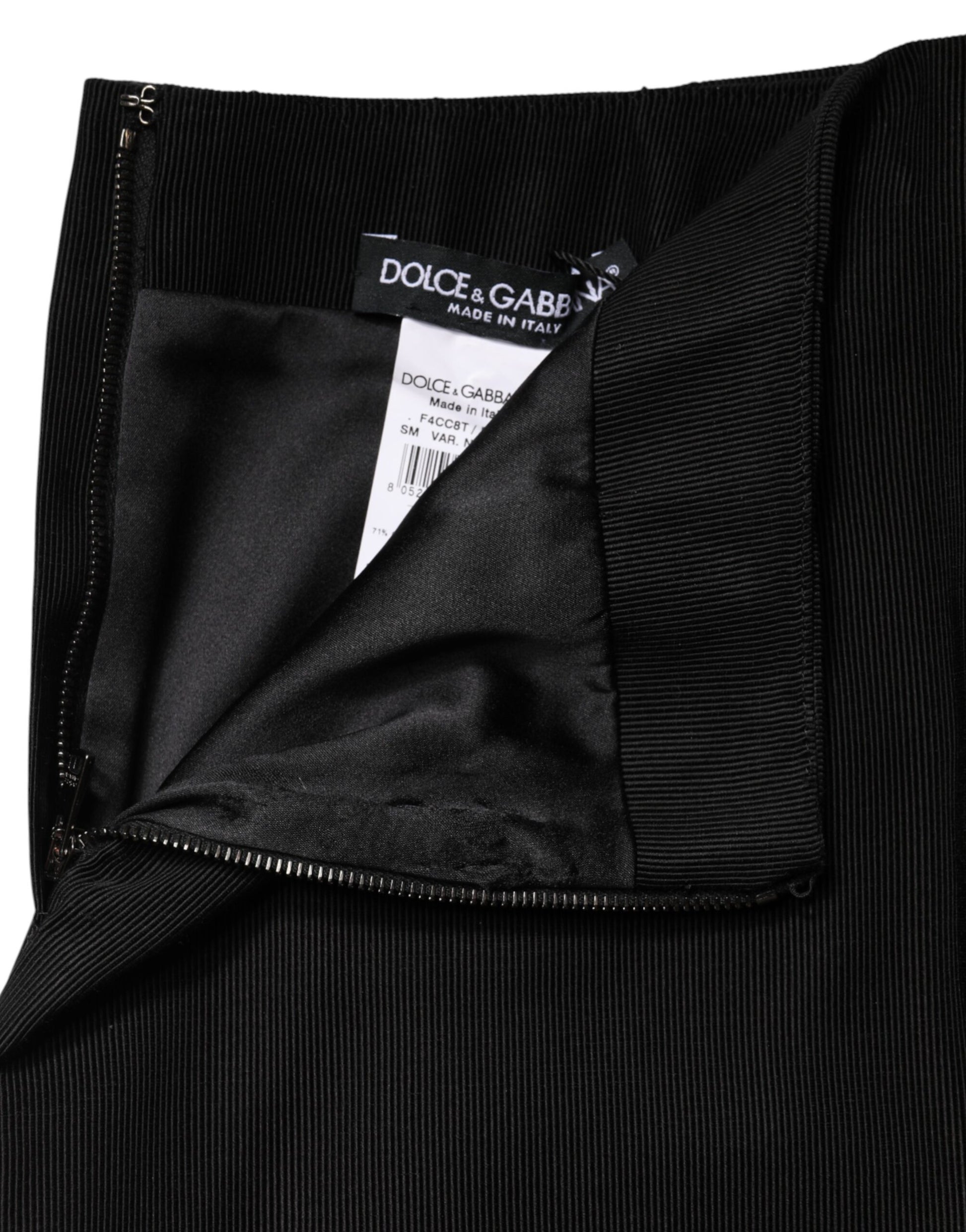 Black velvet pants with a tag inside the pocket
