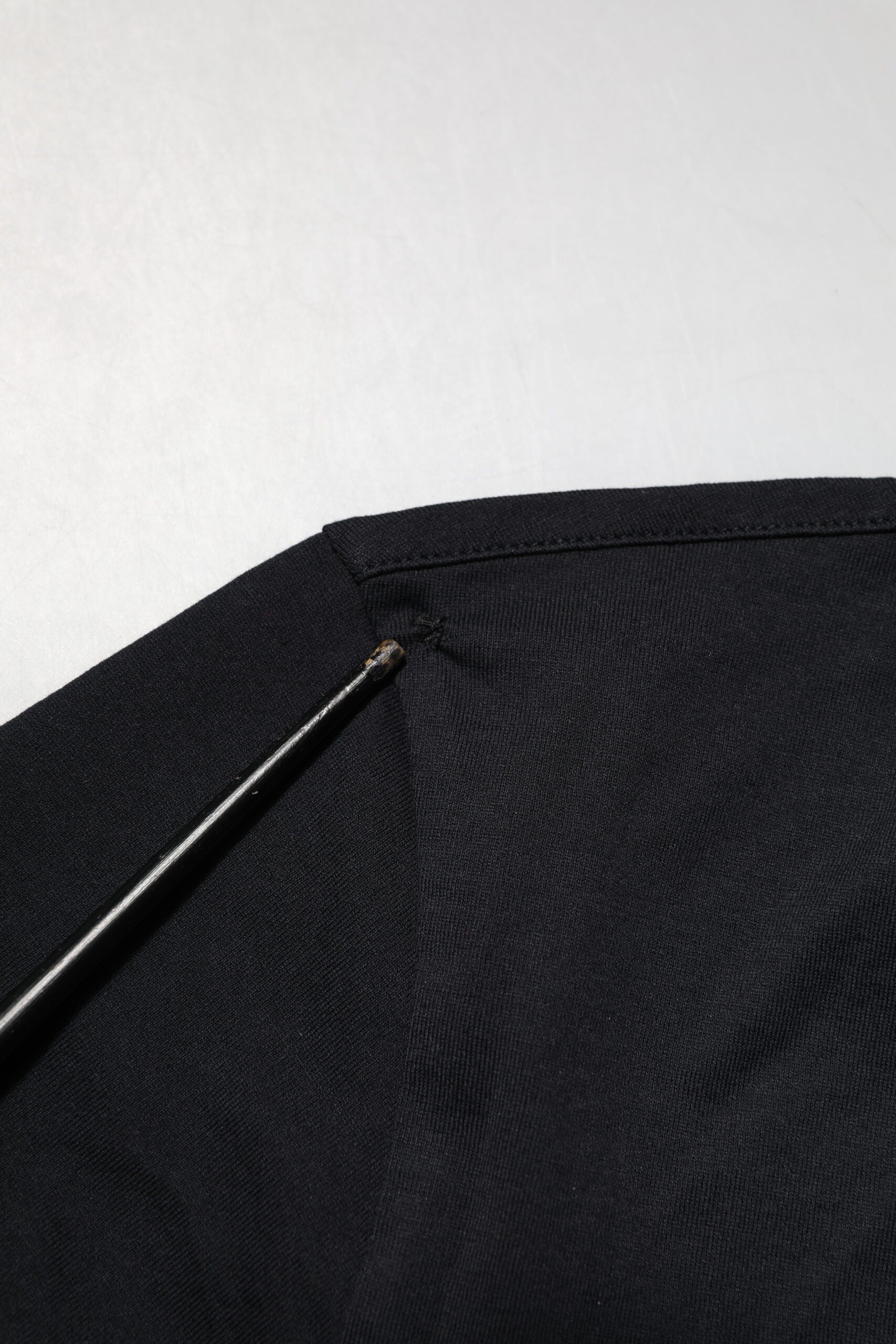 Black fabric with a needle in it