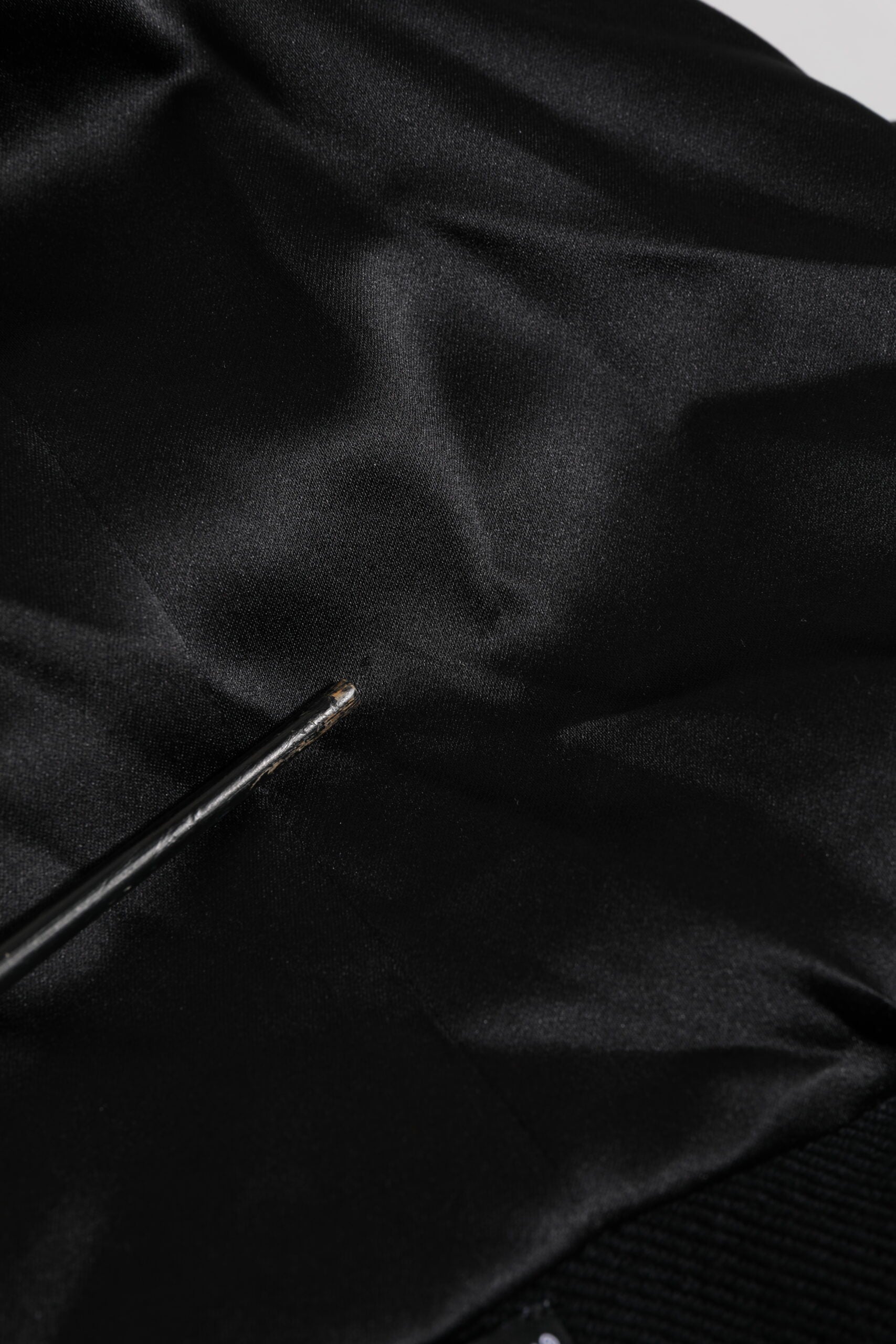 Black fabric with a small hole in it