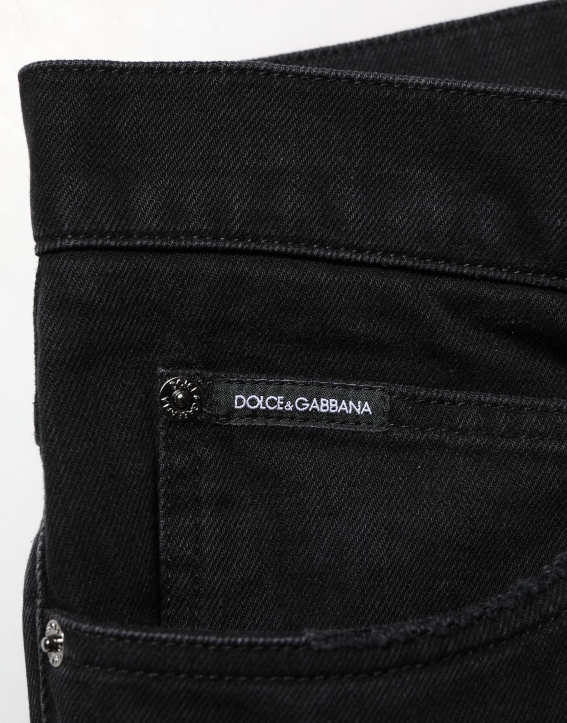Black denim jeans with brand label on waistband