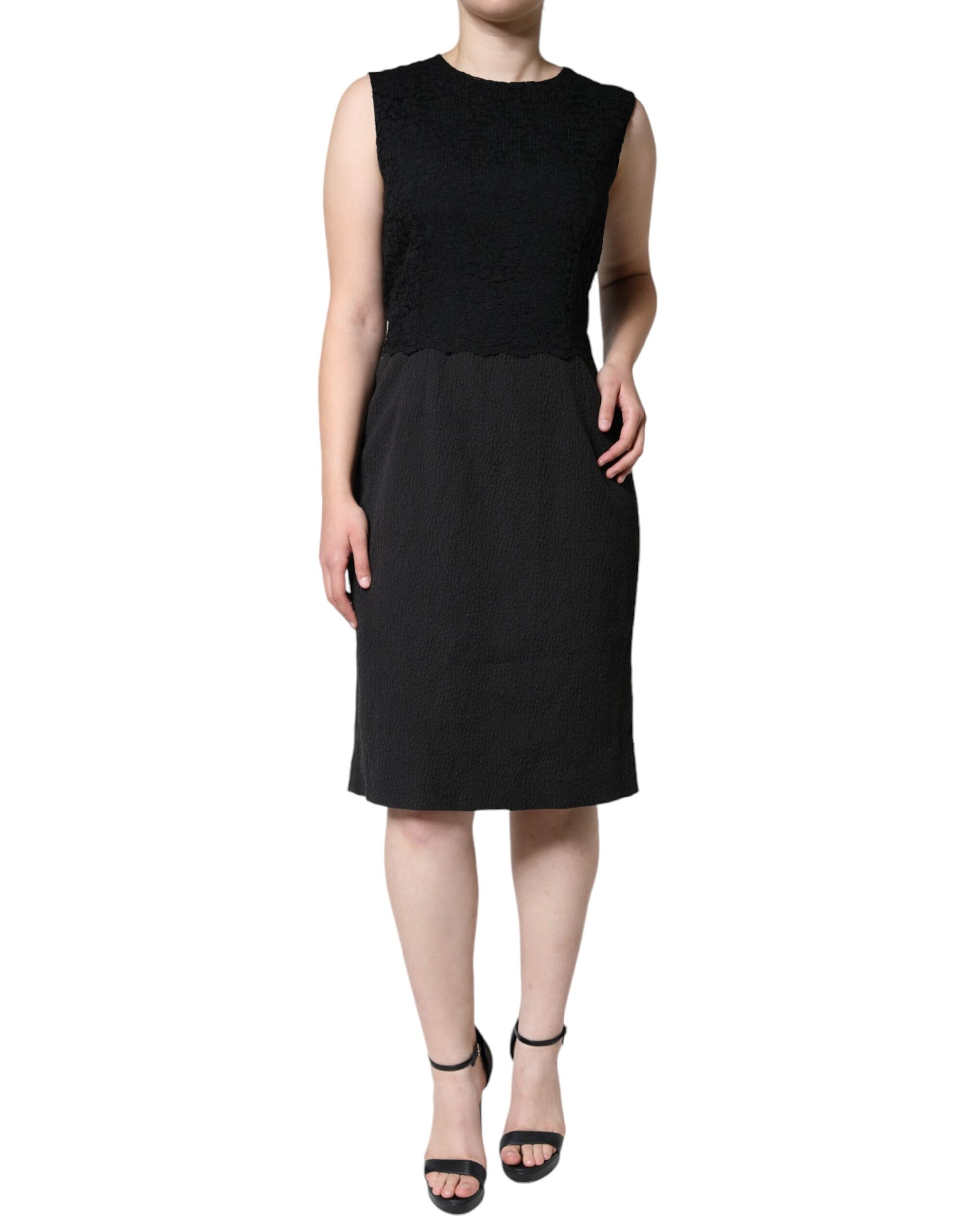 A black knee-length dress with short sleeves and a V-neckline