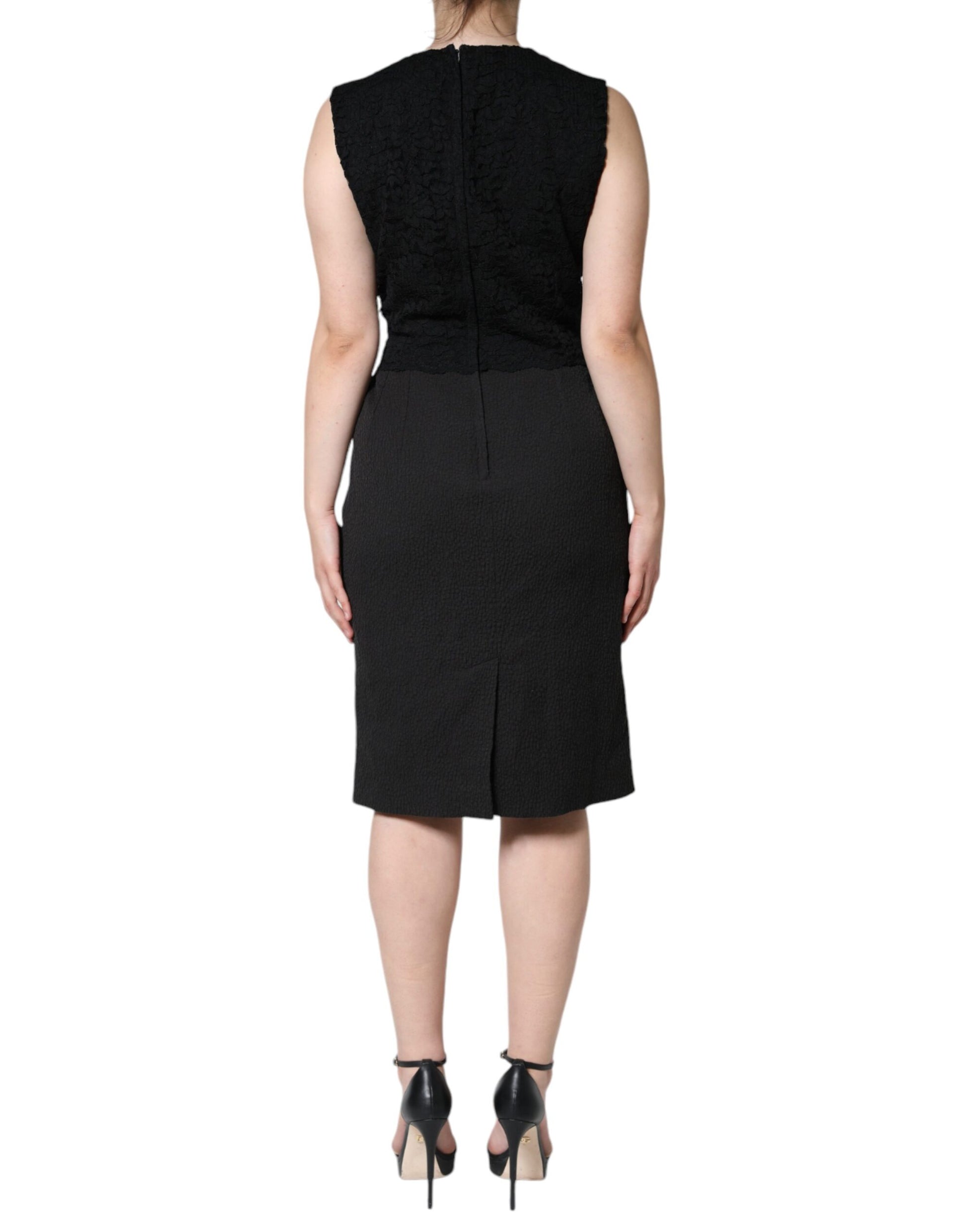 A black knee-length dress with a V-neckline and short sleeves