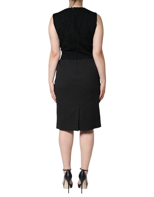 A black knee-length dress with a V-neckline and short sleeves