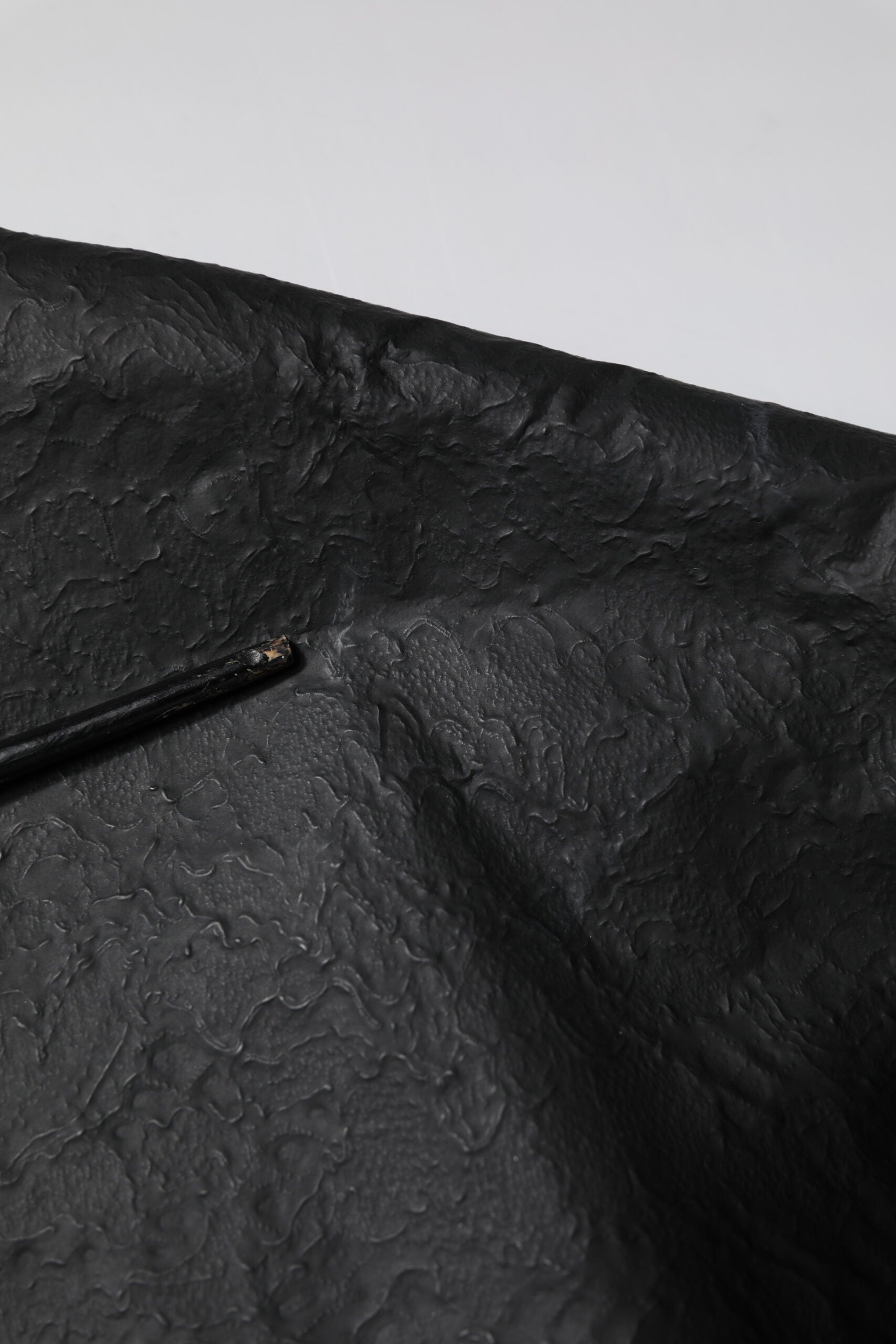 Black umbrella on white surface