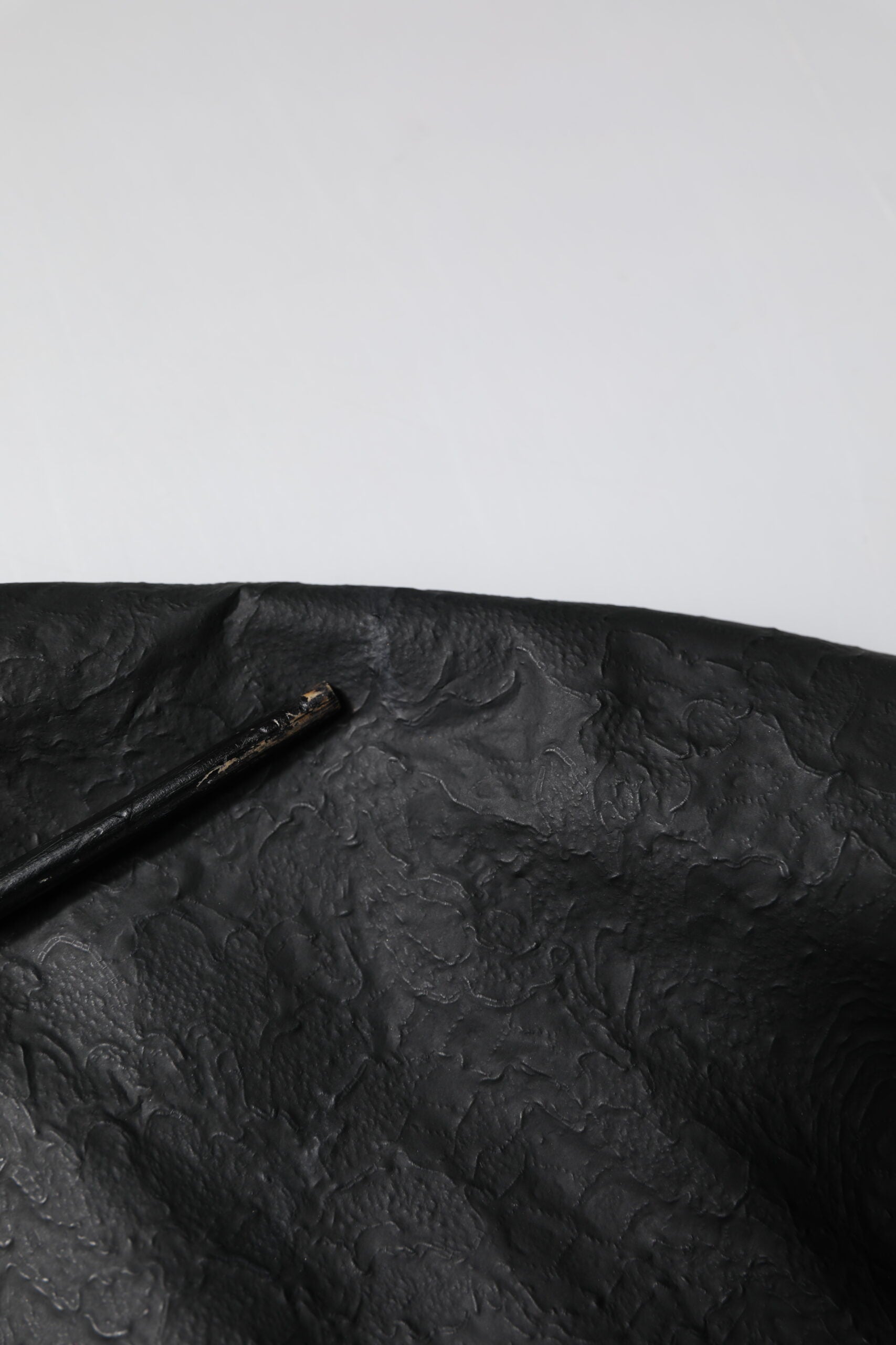 Black umbrella on a black surface