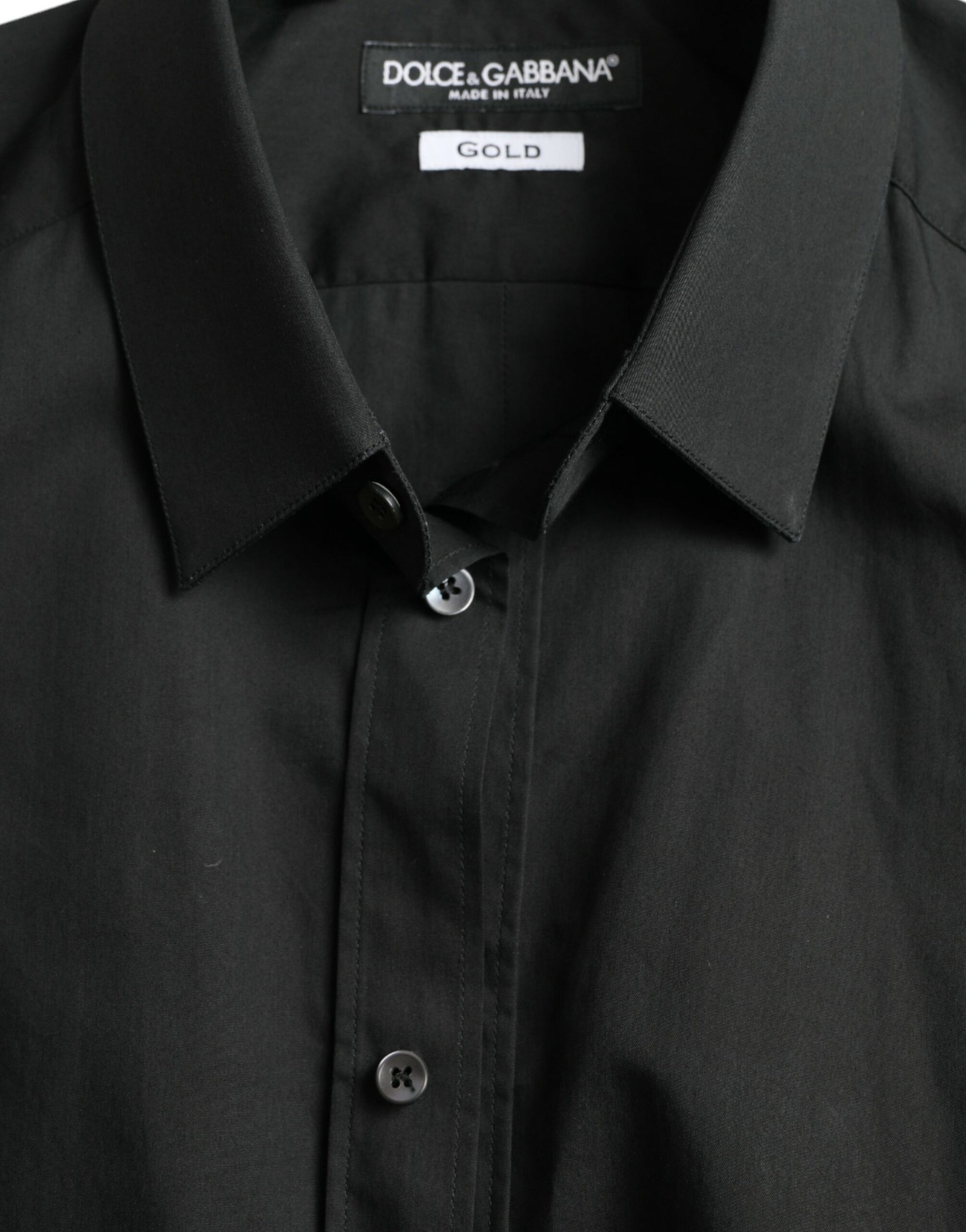 Black shirt on hanger with gold label