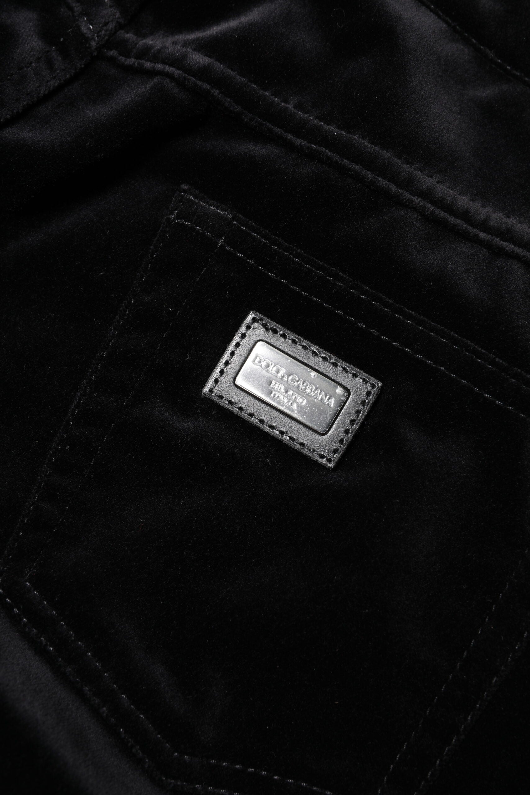 Black velvet jacket with a label on the left chest area