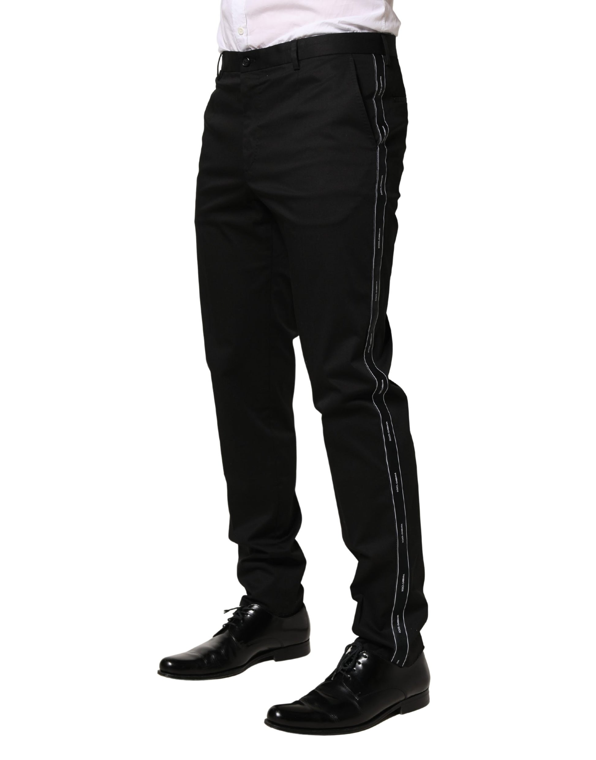 A pair of black cotton skinny men's dress trousers with white stripes down the sides