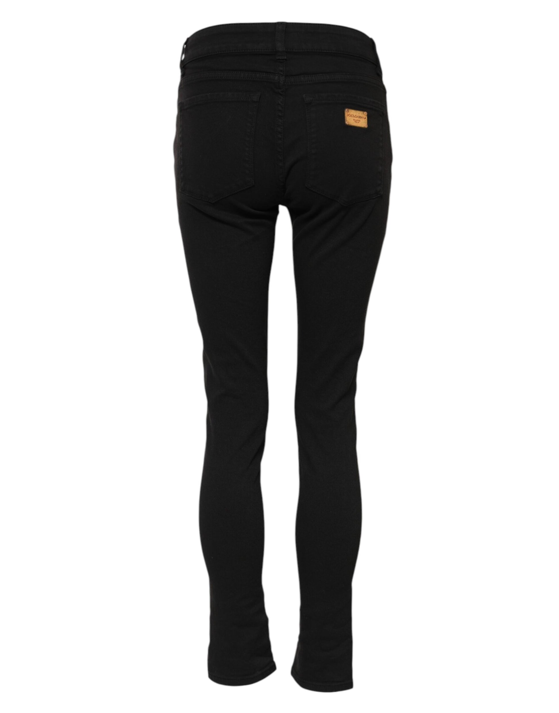 Black skinny jeans with a yellow tag on waistband