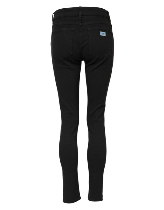 Pair of black jeans with a visible logo on the back right leg