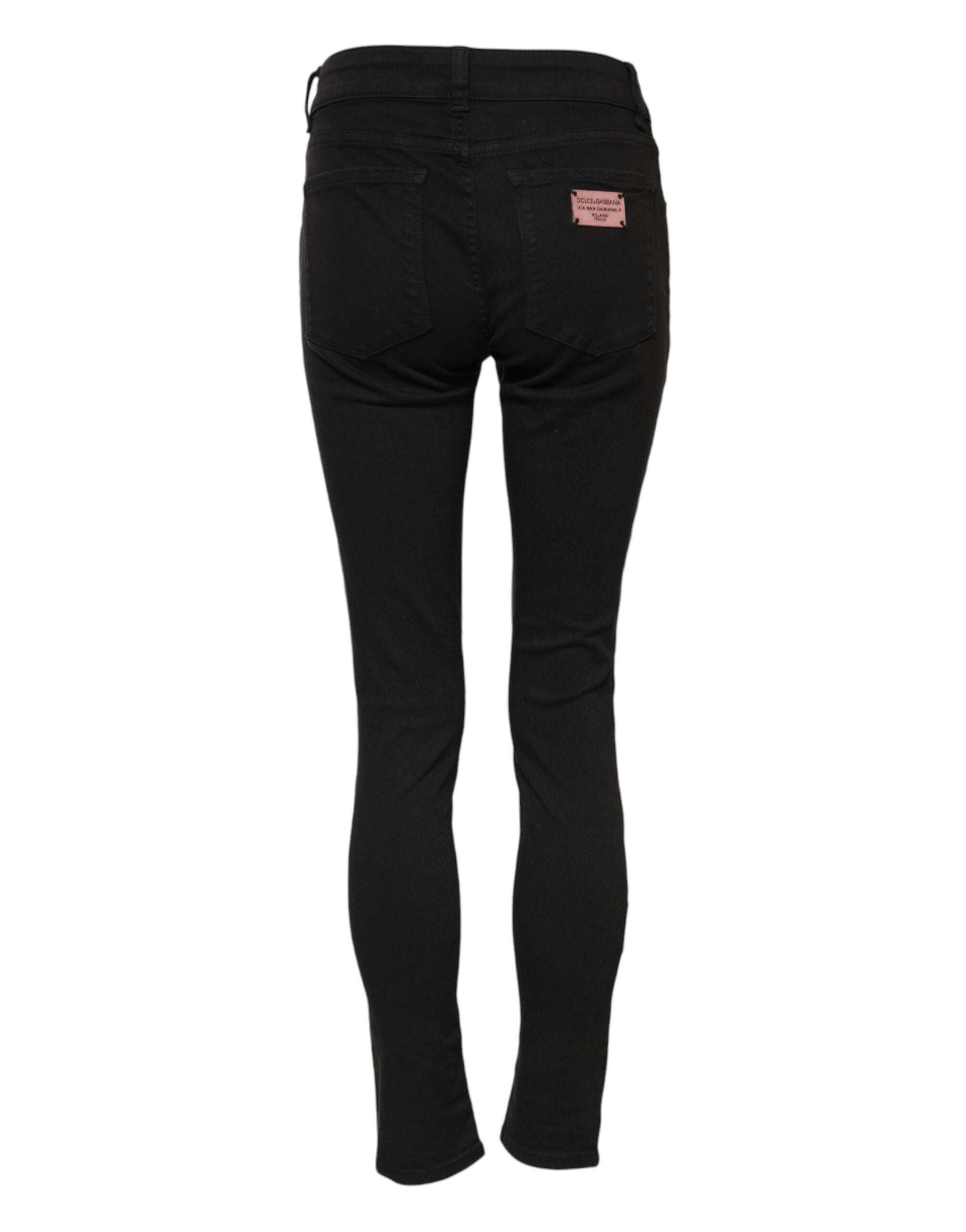 Black skinny jeans with a pink label on waistband