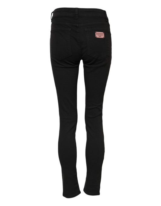 Black skinny jeans with a pink label on waistband