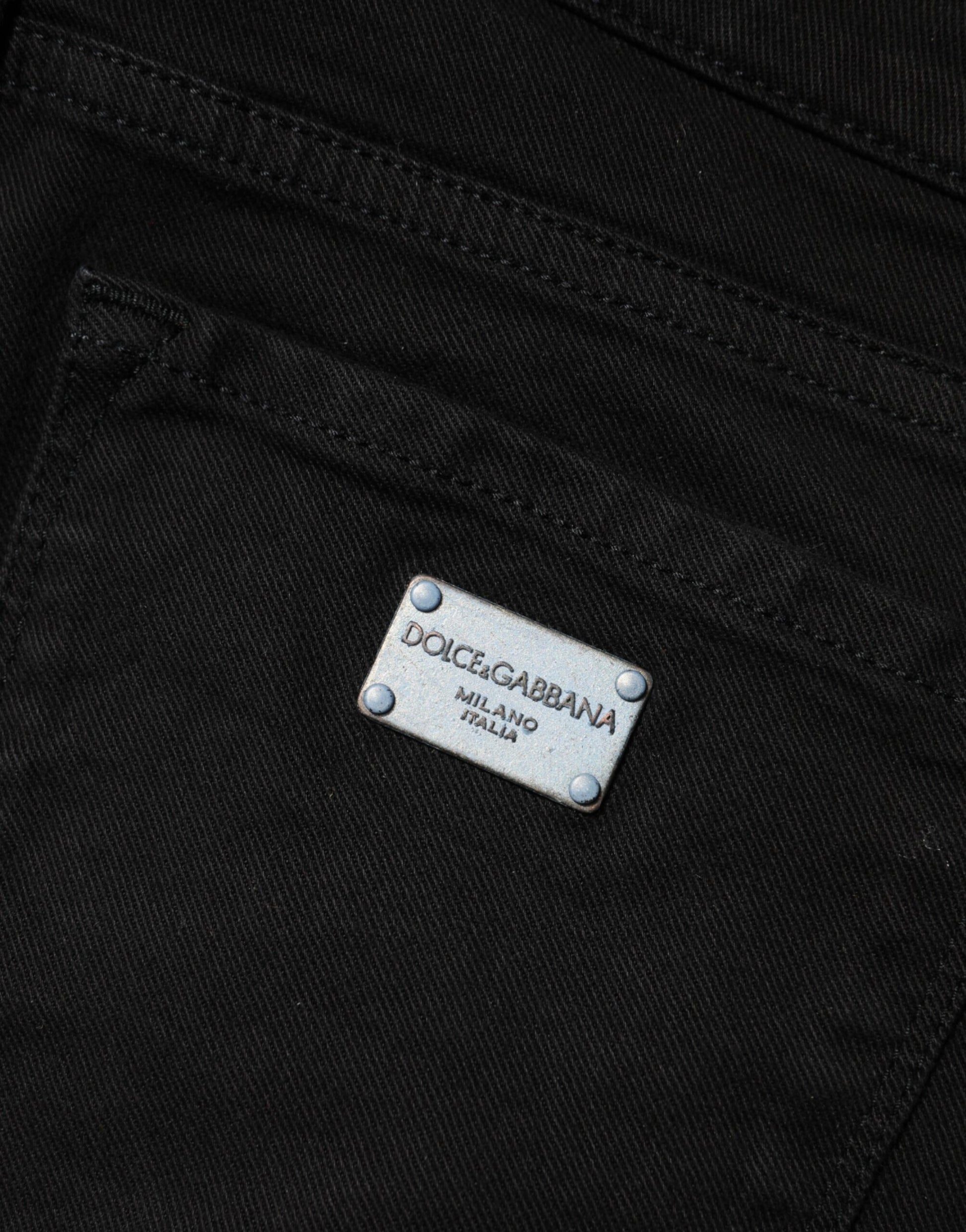 The jeans have a silver label on the front pocket
