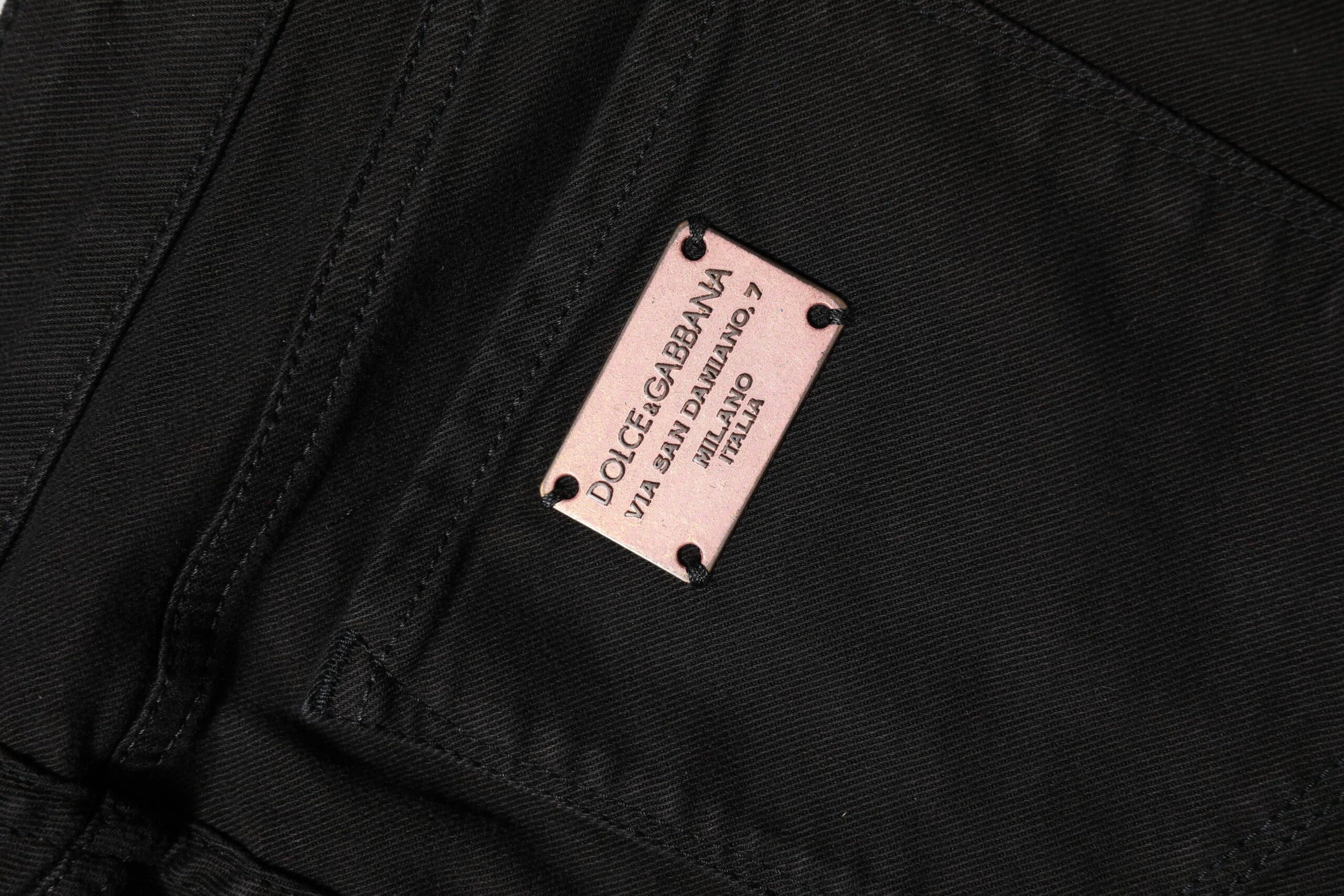 Pair of black jeans with pink label inside pocket