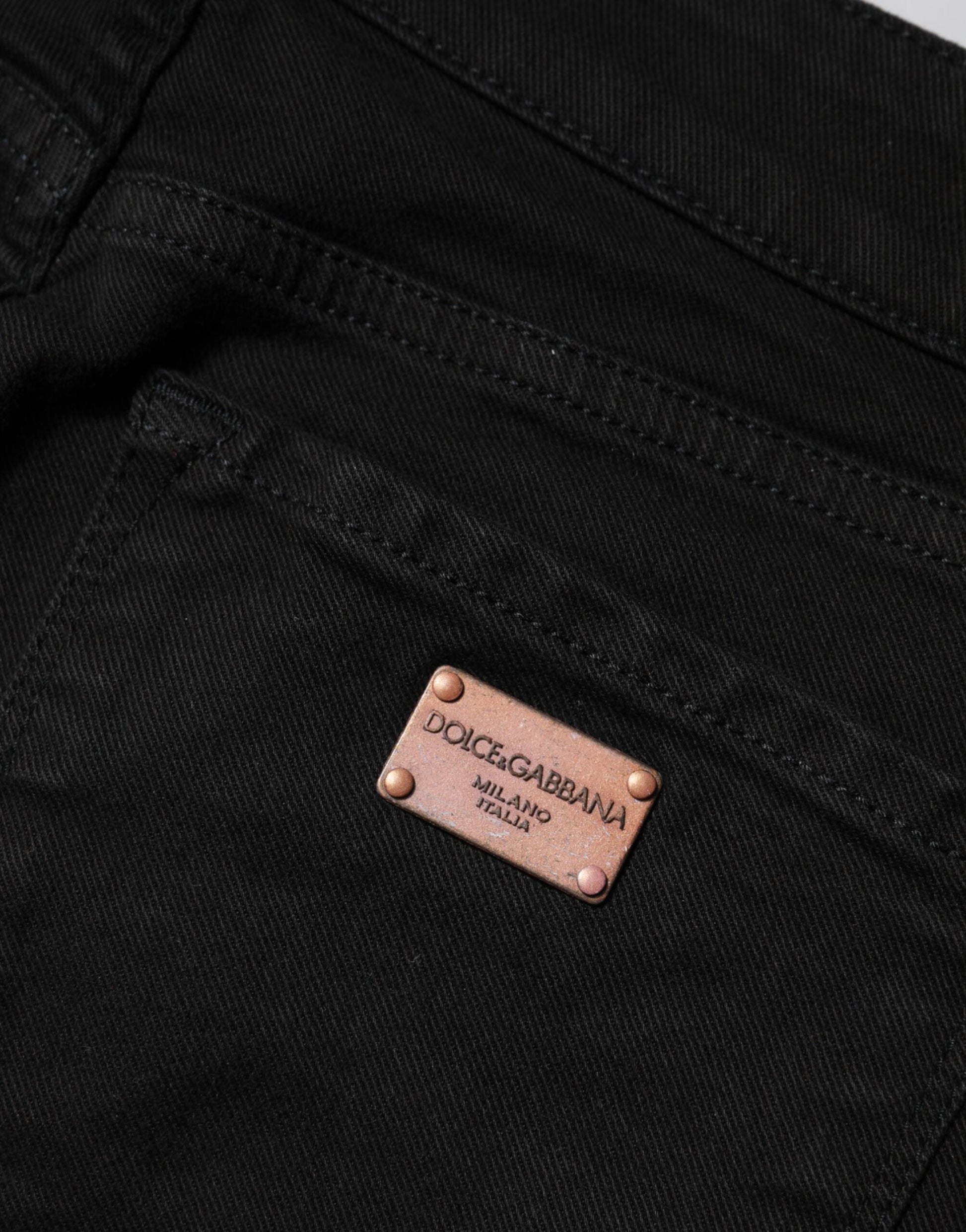 Black denim jeans with a brand label on the waistband