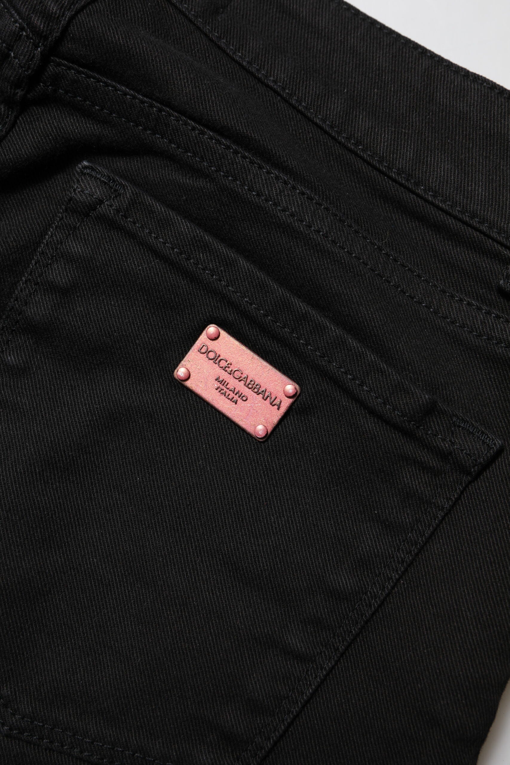Pair of black jeans with pink label on waistband
