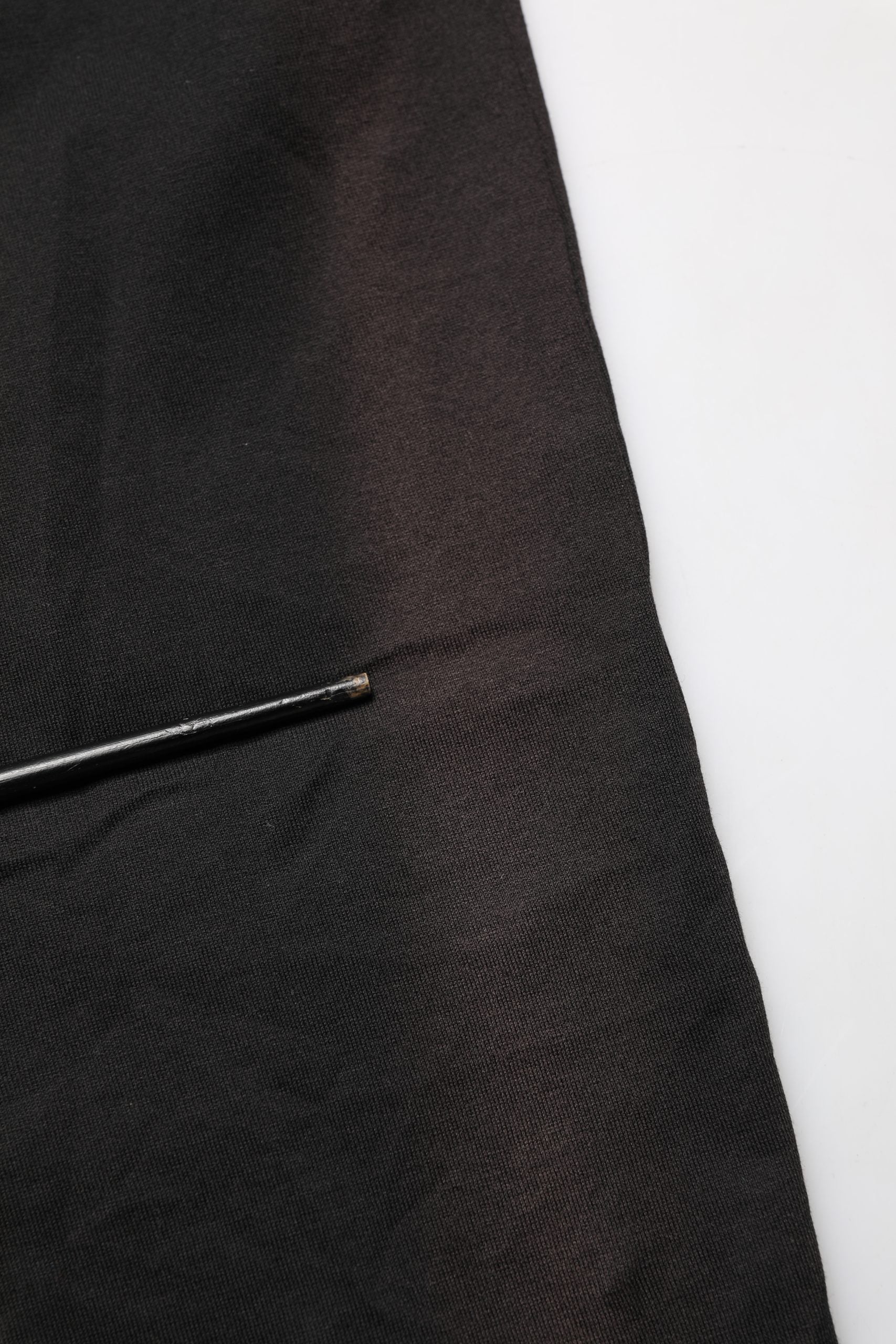 A black cotton sleeveless men's tank top t-shirt with a pin in the fabric