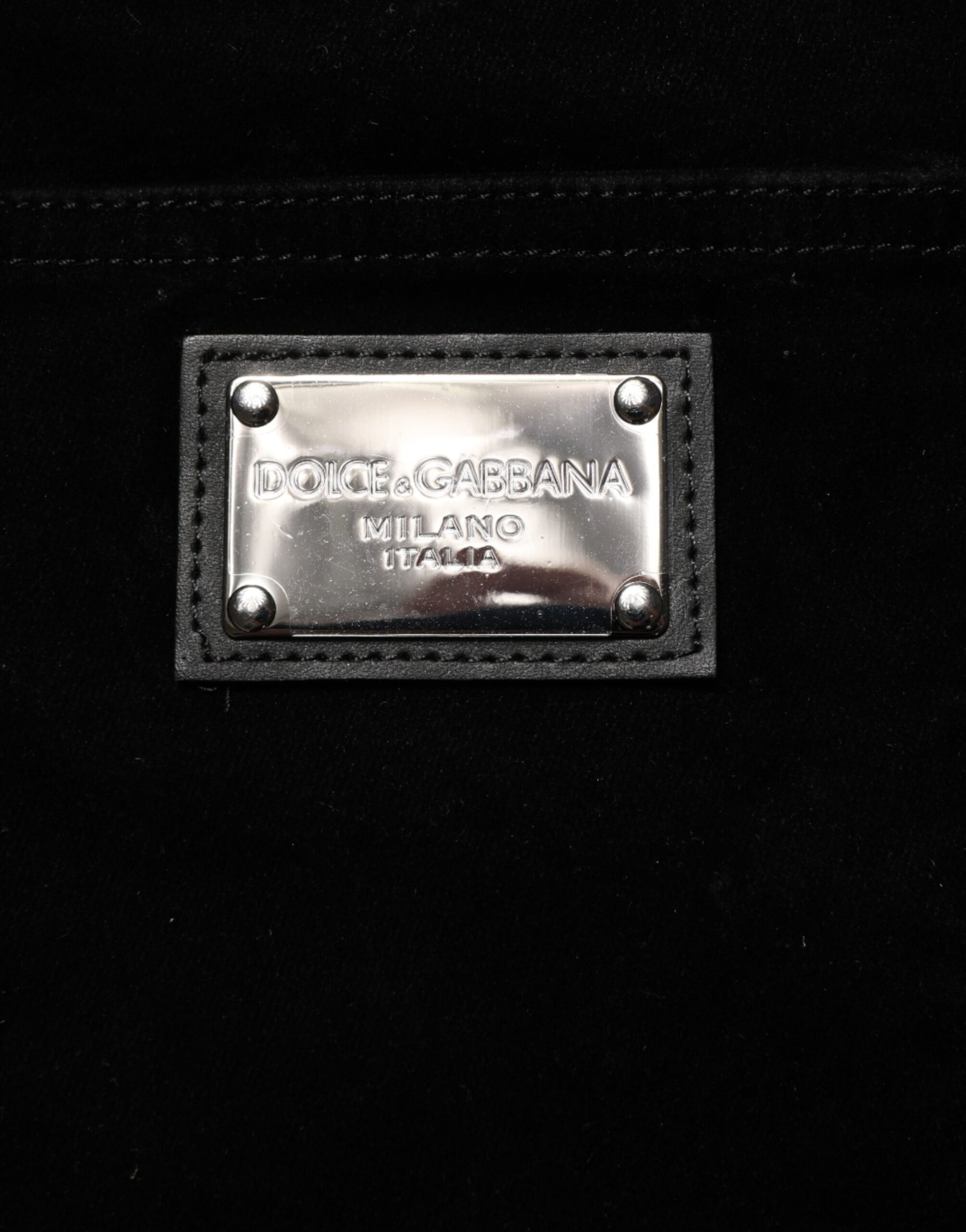 The tag is on a black fabric surface