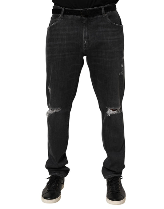 Pair of dark blue denim jeans with distressed areas on legs