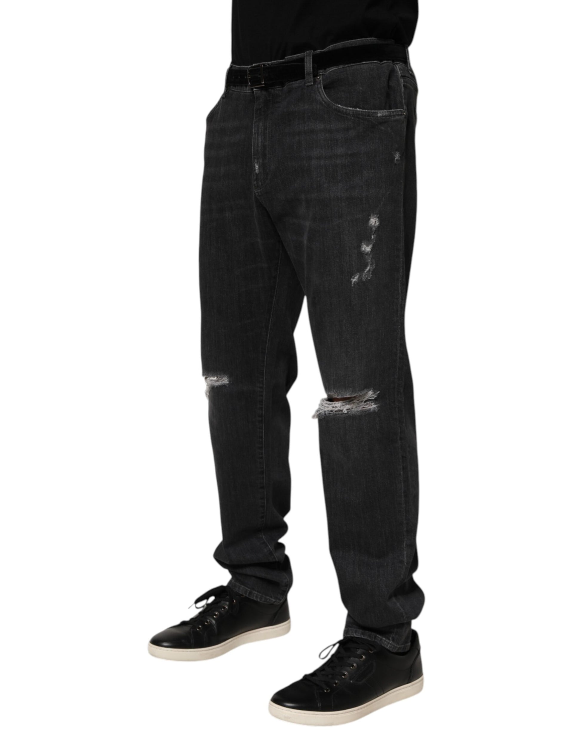 Man wearing blue jeans with holes in knees