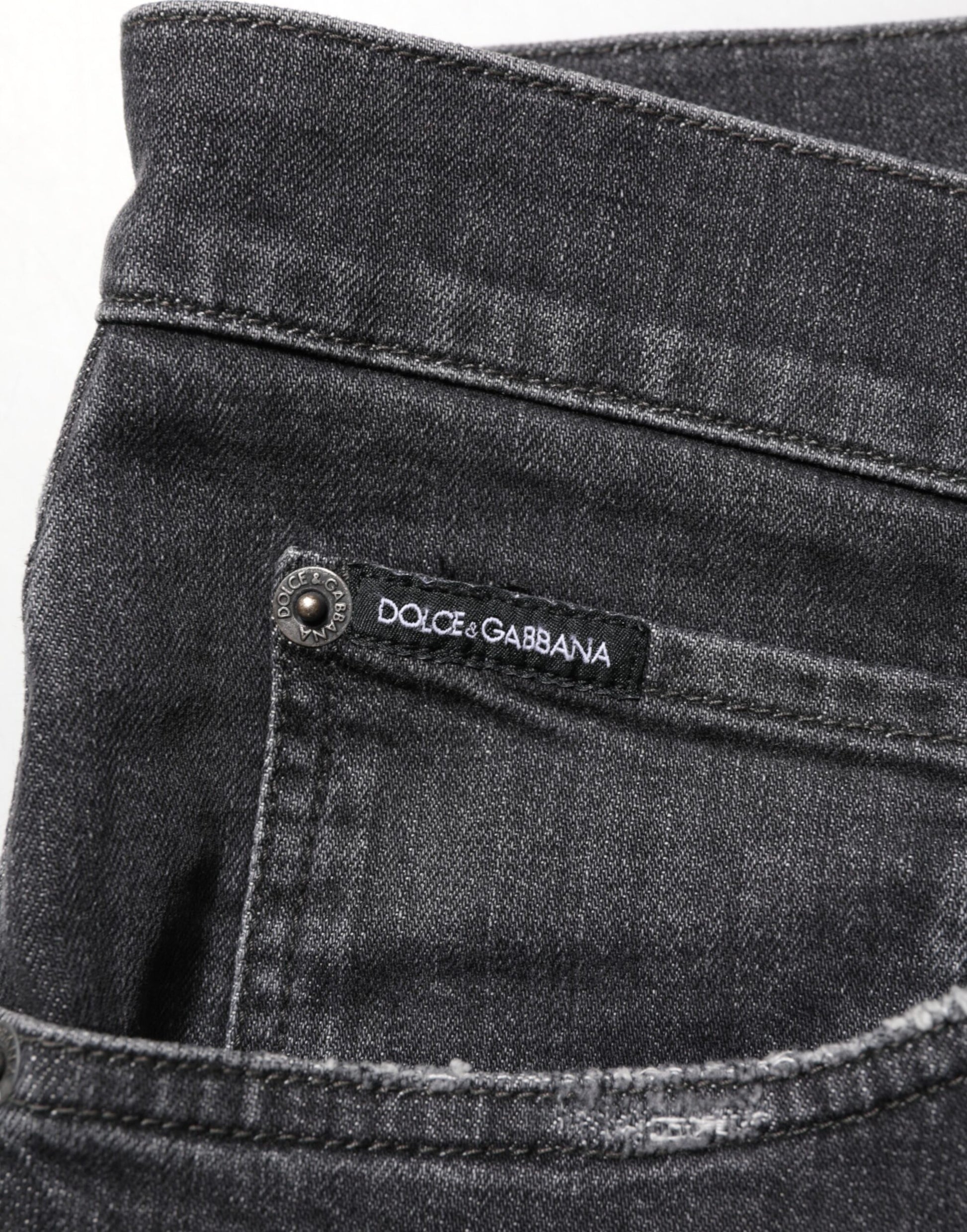 Pair of blue jeans with a brand label on the right side pocket