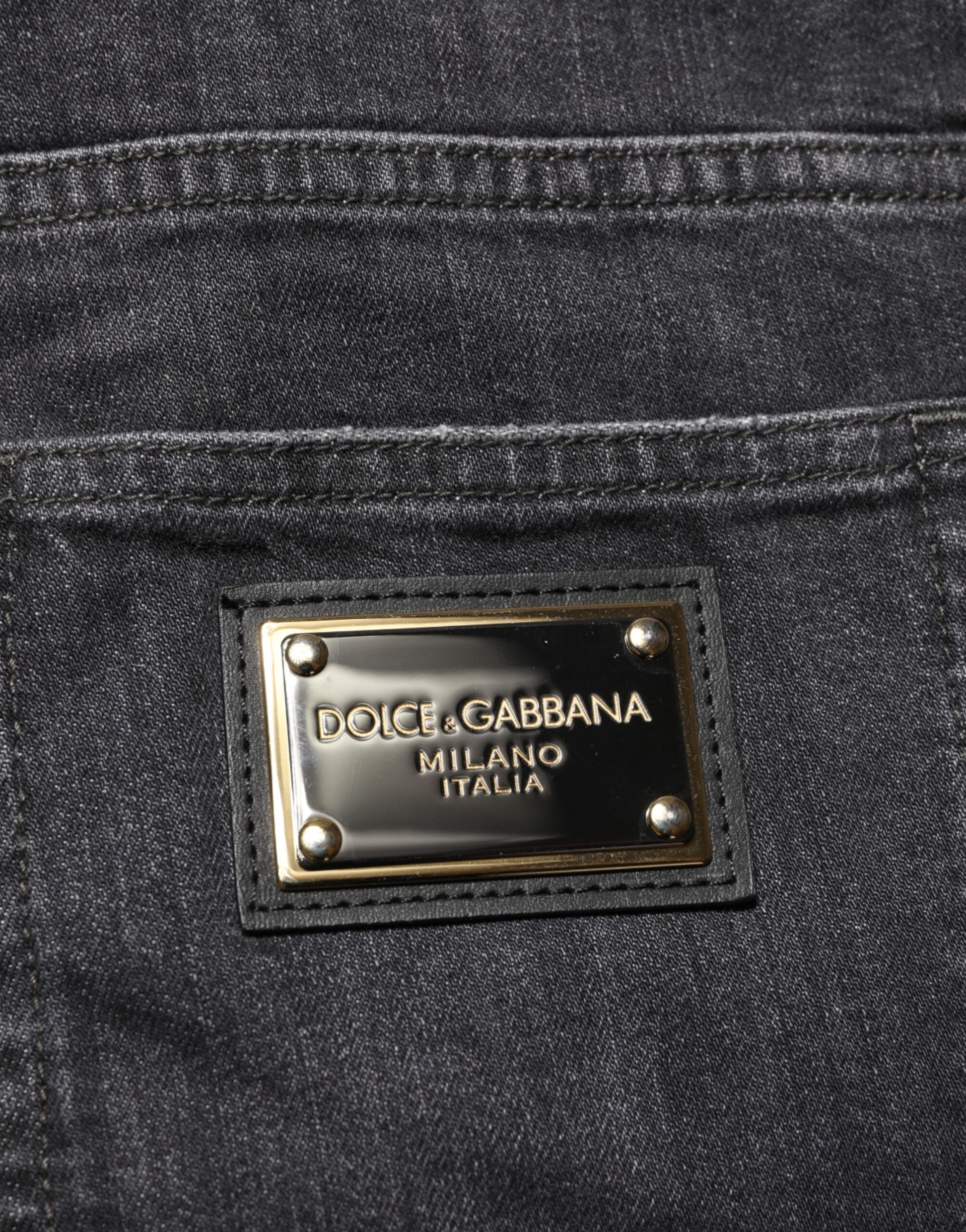 The jeans have a gold zipper tag on them