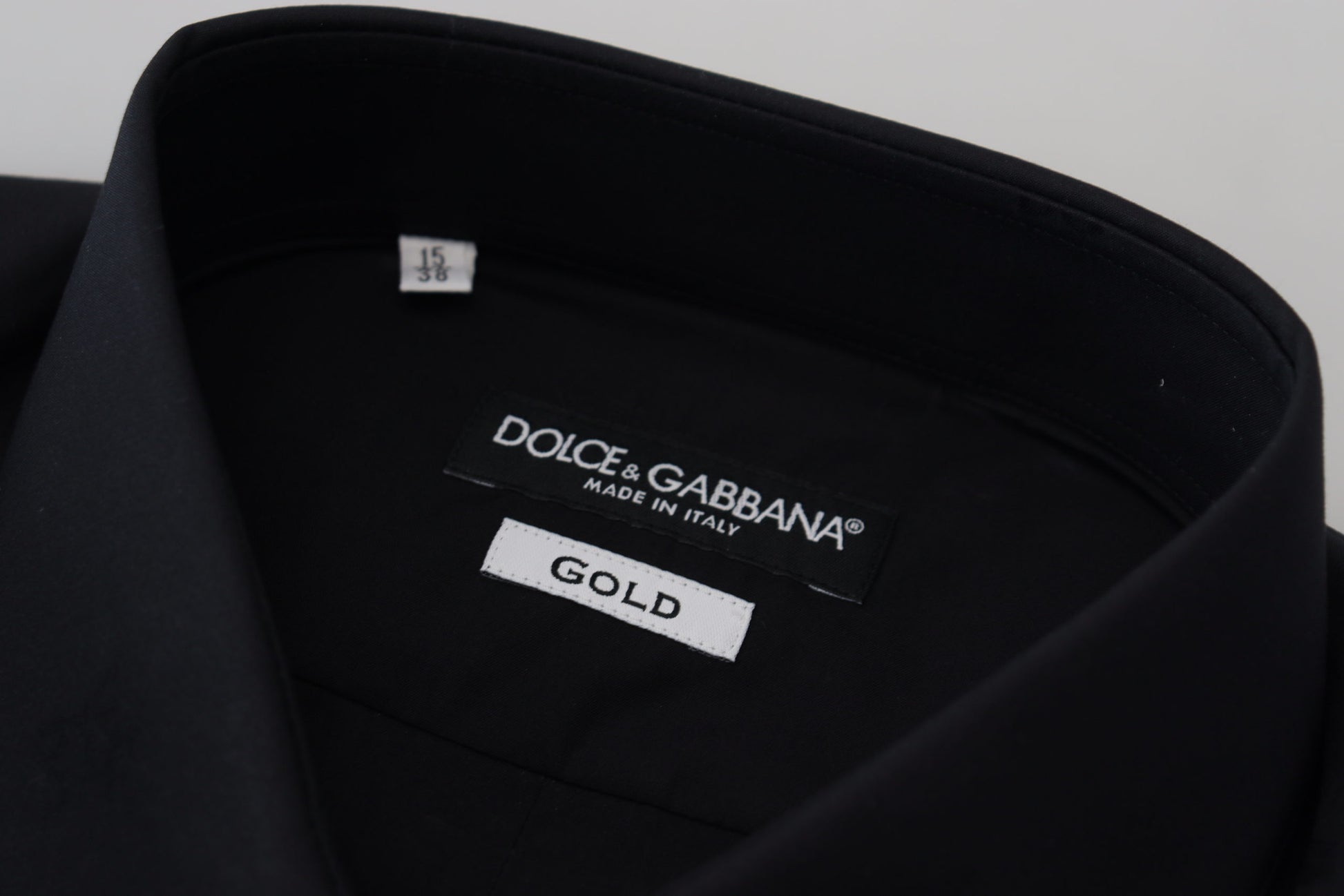A black cotton slim fit formal dress shirt with a gold label