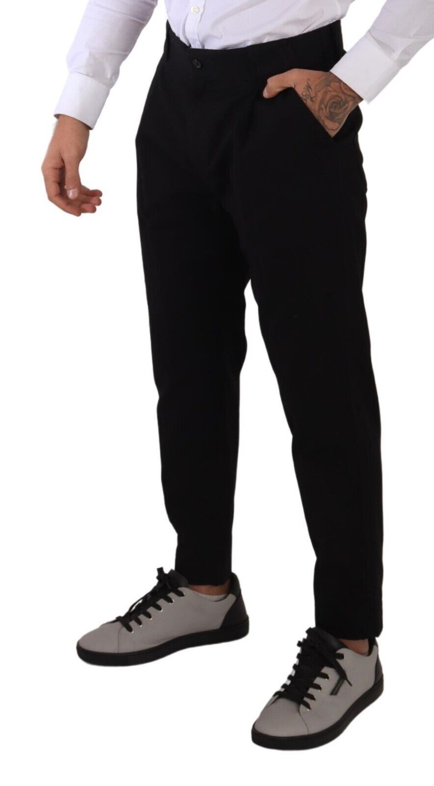 Man wearing black pants and grey sneakers
