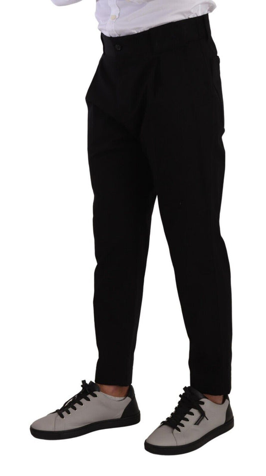 Man wearing black pants, white shirt, and sneakers