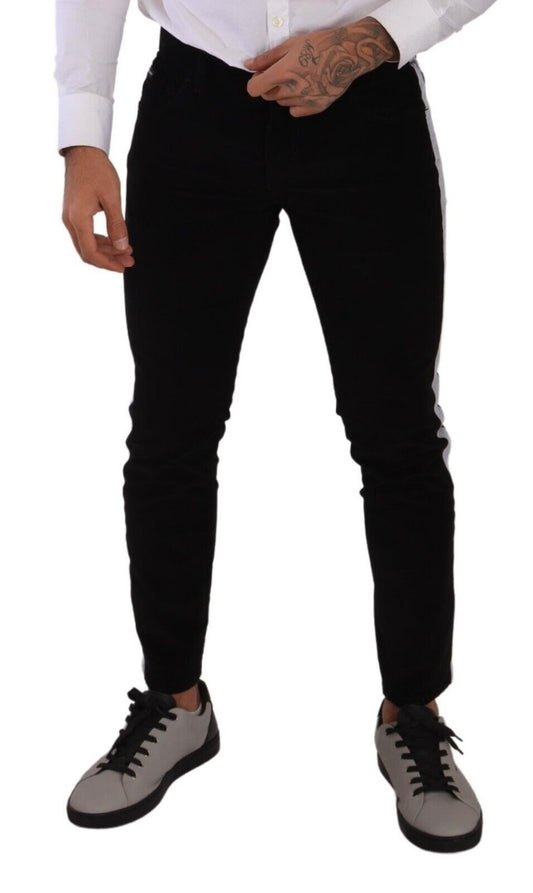 Man wearing black pants, white shirt, and grey shoes