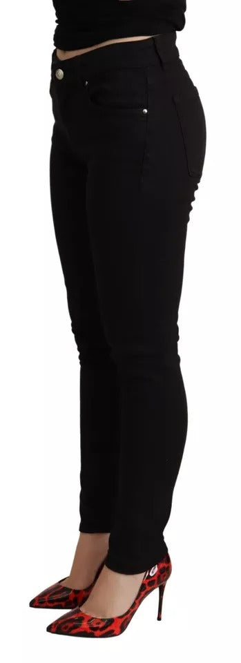 Woman wearing black pants and red shoes