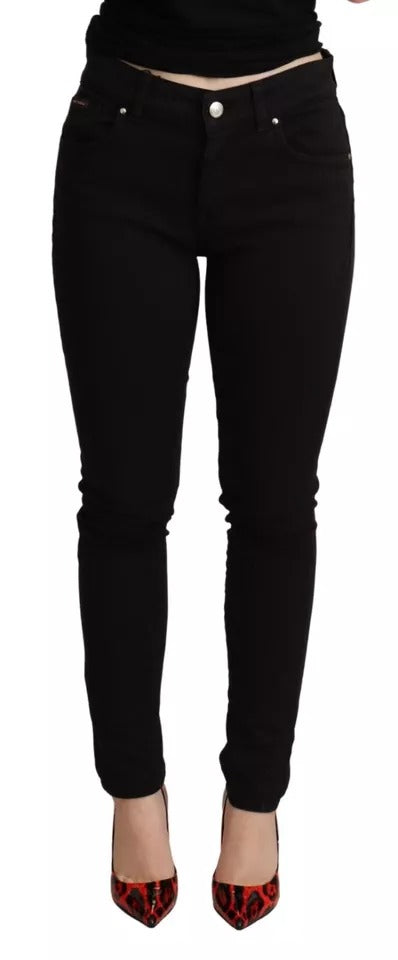 Woman wearing black pants and red shoes