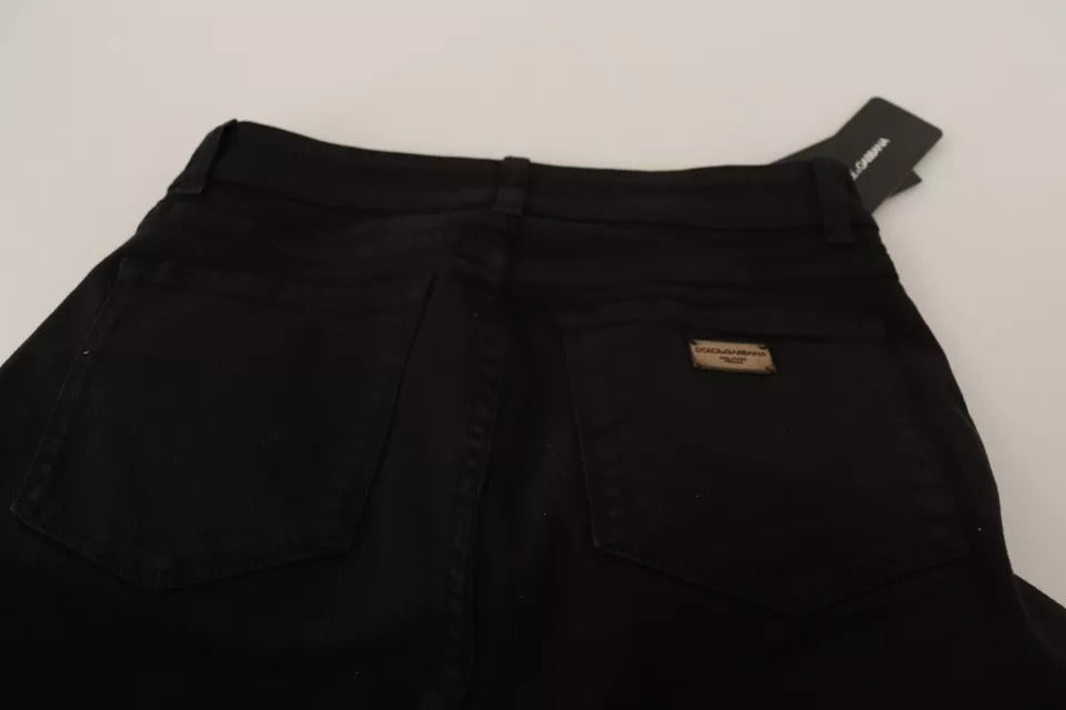 Pair of black jeans with a small logo on the right leg
