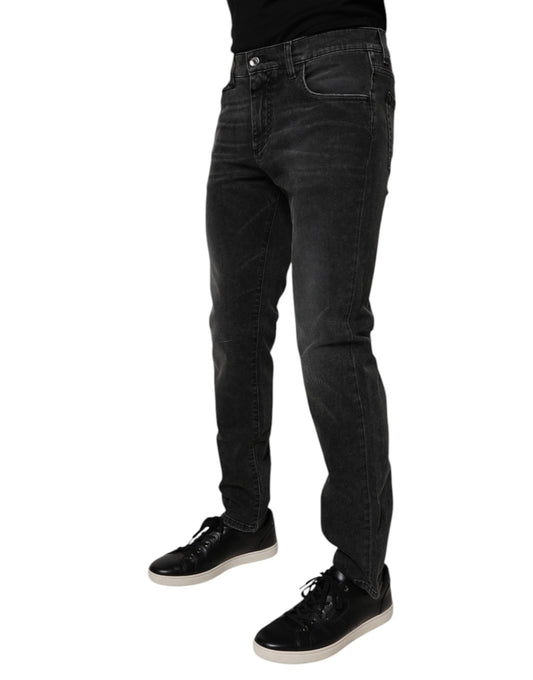 Man wearing dark jeans and black shoes