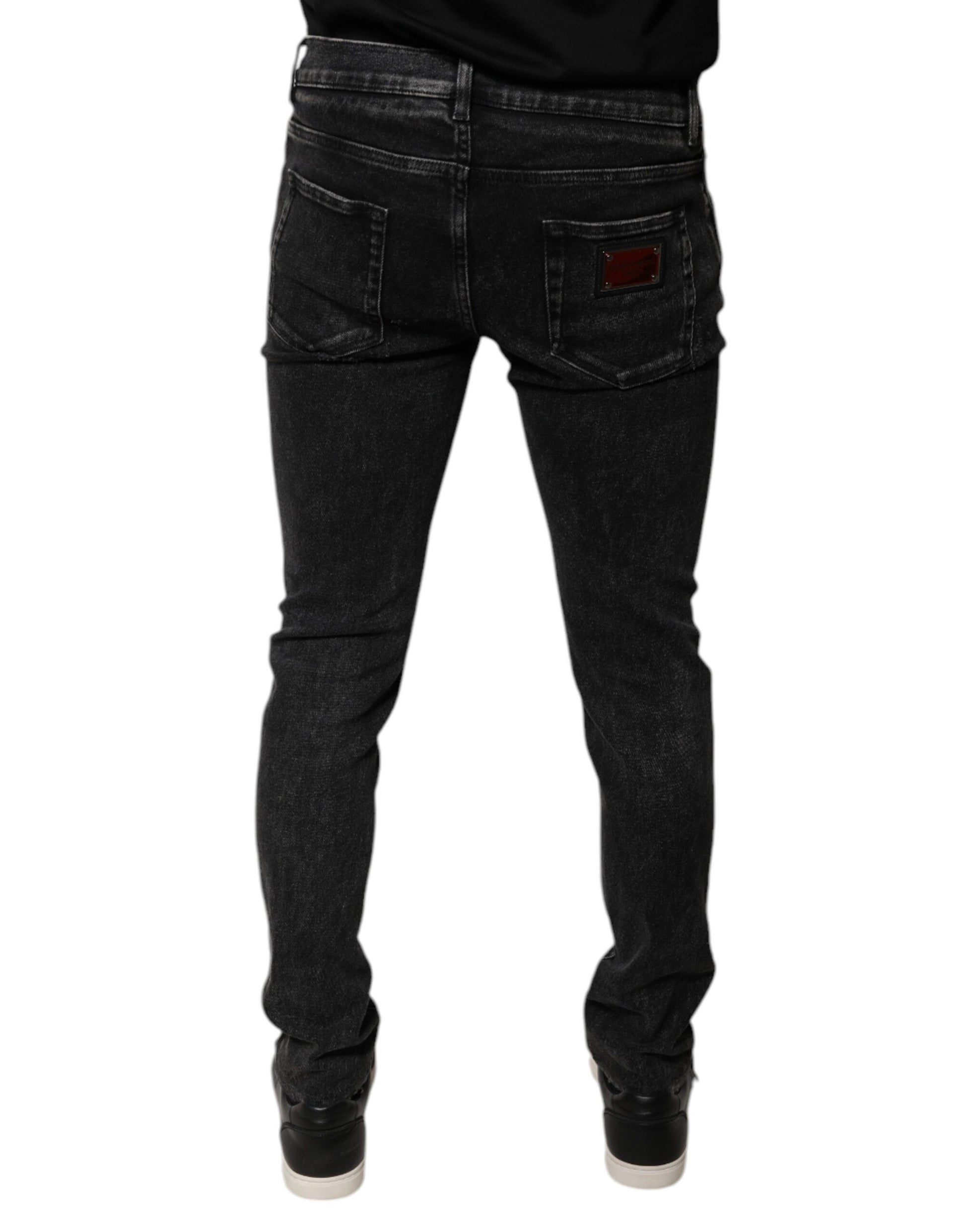 Pair of dark wash jeans with a red logo on back pocket