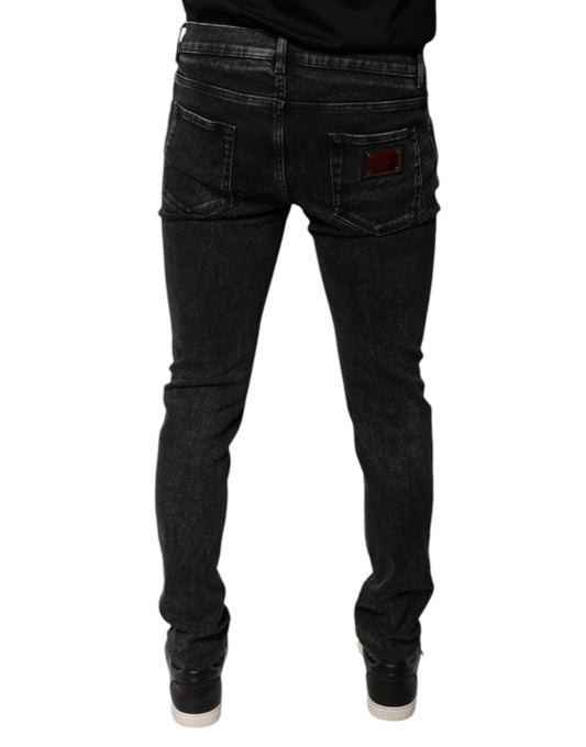 Pair of dark wash jeans with a red logo on back pocket