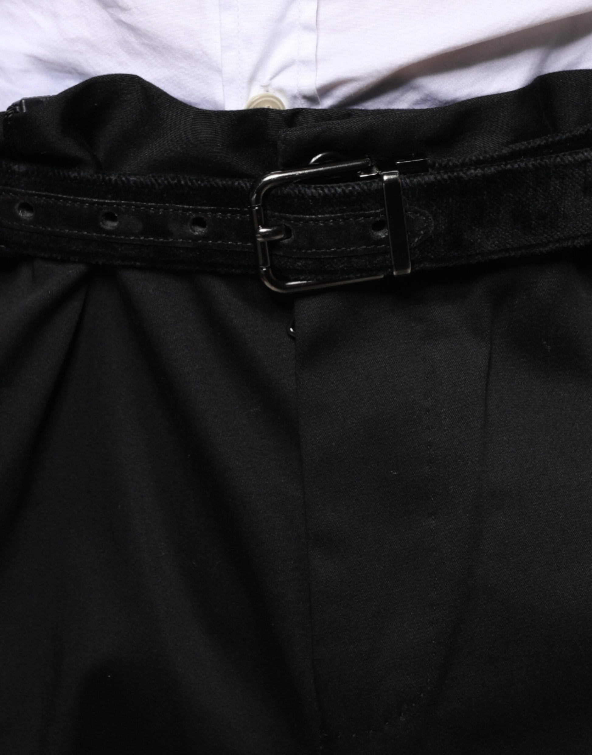 A pair of black cotton stretch skinny men's dress pants with a belt loop and button closure