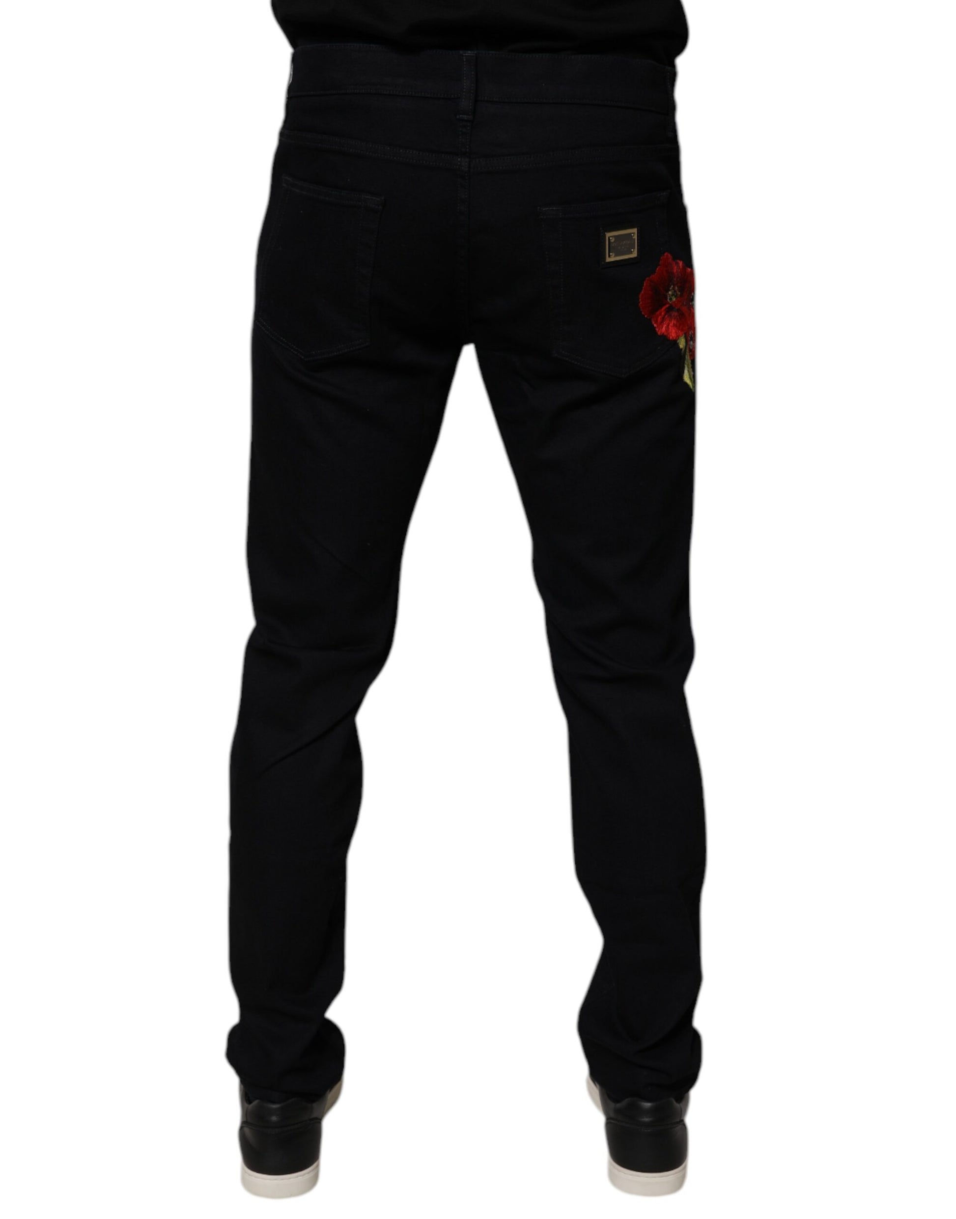 Pair of black jeans with red flower embroidery on left leg