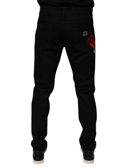 Pair of black jeans with red flower embroidery on left leg