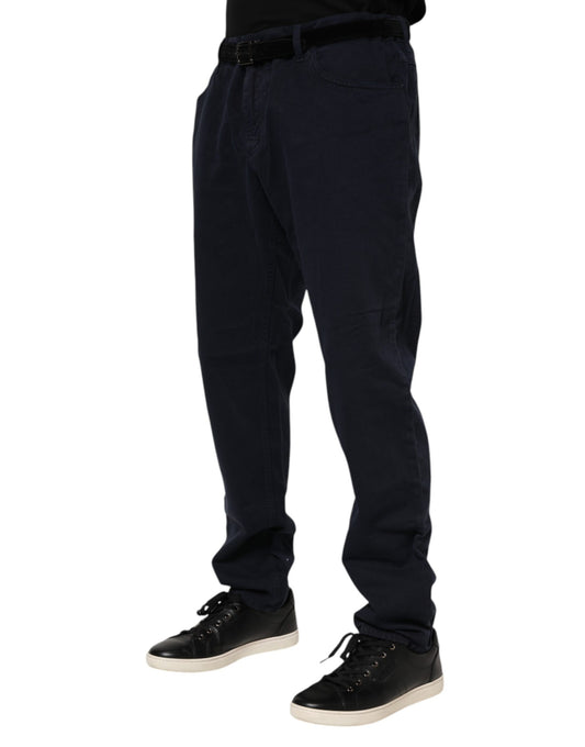 Man wearing dark blue pants and black shoes