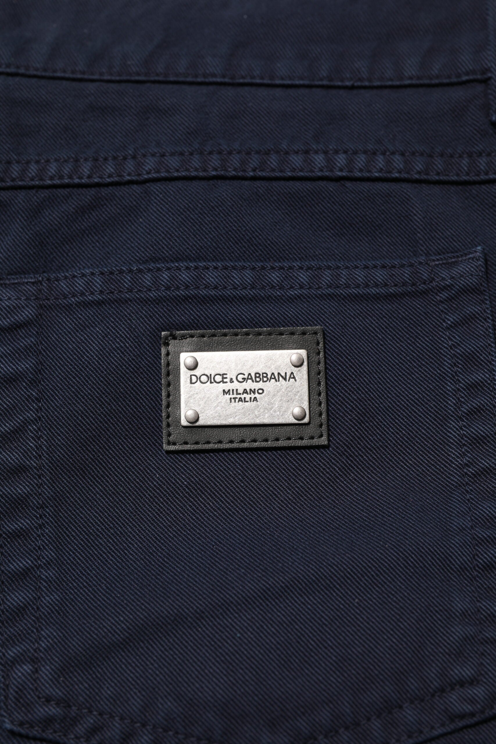 Blue denim jeans with a label on the back pocket